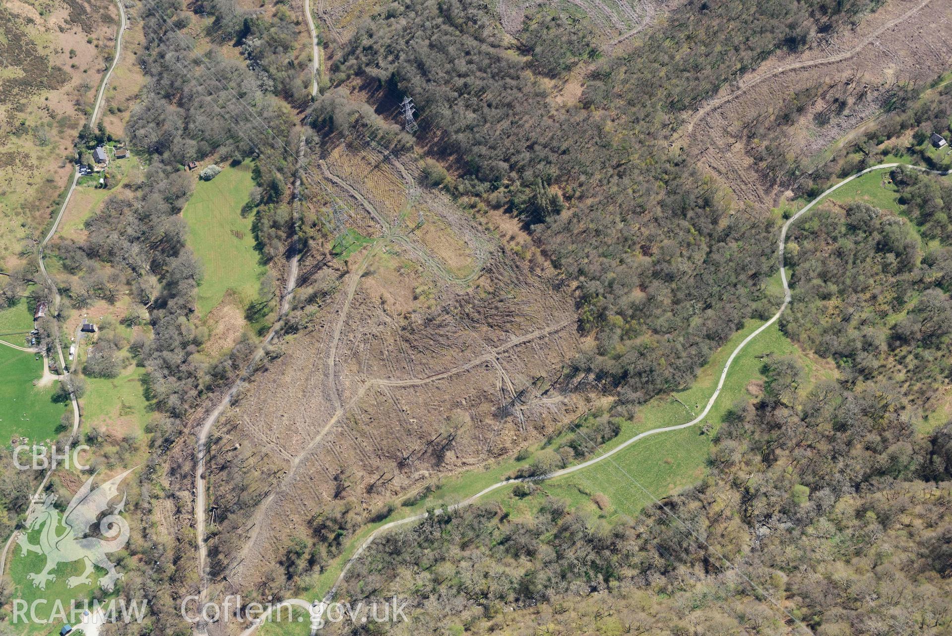 Coedydd Aber Nature Reserve, woodland clearance along power lines.  Oblique aerial photograph taken during the Royal Commission’s programme of archaeological aerial reconnaissance by Toby Driver on 20 April 2018.