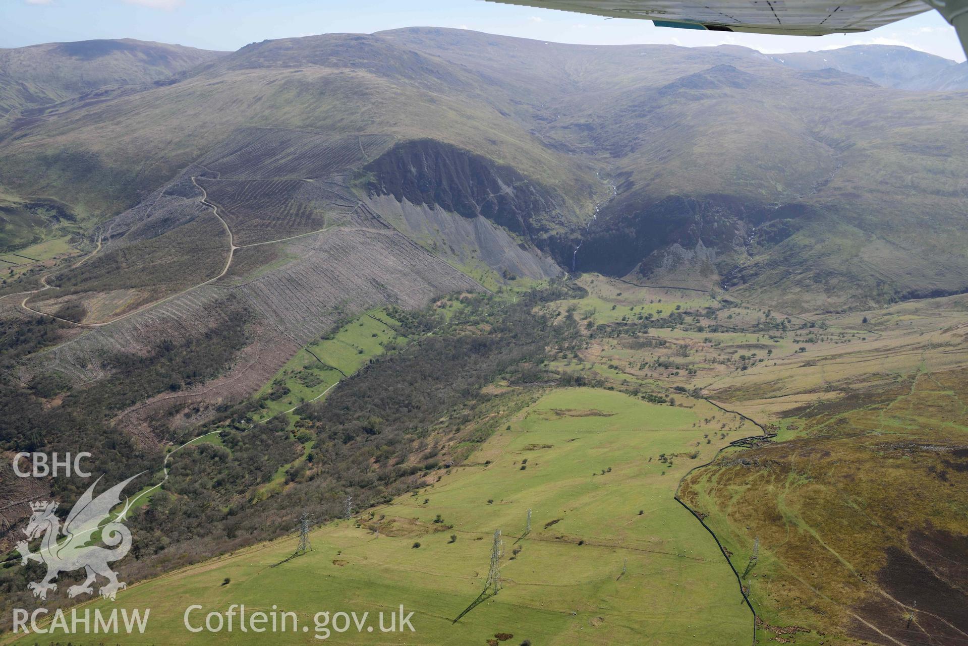 Coedydd Aber Nature Reserve, landscape view from north-west. Oblique aerial photograph taken during the Royal Commission’s programme of archaeological aerial reconnaissance by Toby Driver on 20 April 2018.