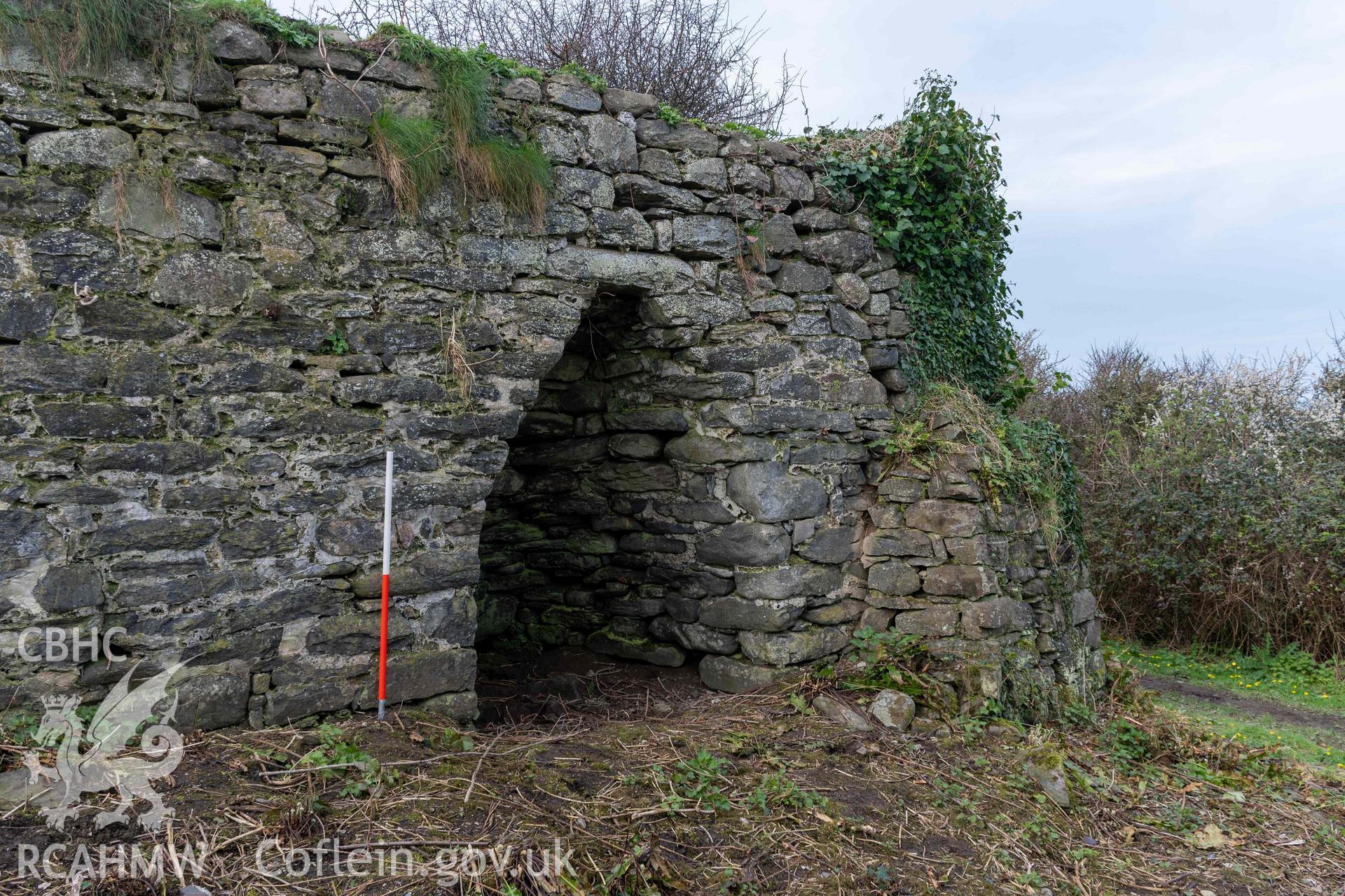 Kiln 4, kiln-eye and butress, east elevation (with scale). Part of photographic survey of Aberstrincell lime kilns and coal yard, conducted by Louise Barker of the RCAHMW survey team on 21 March 2024.