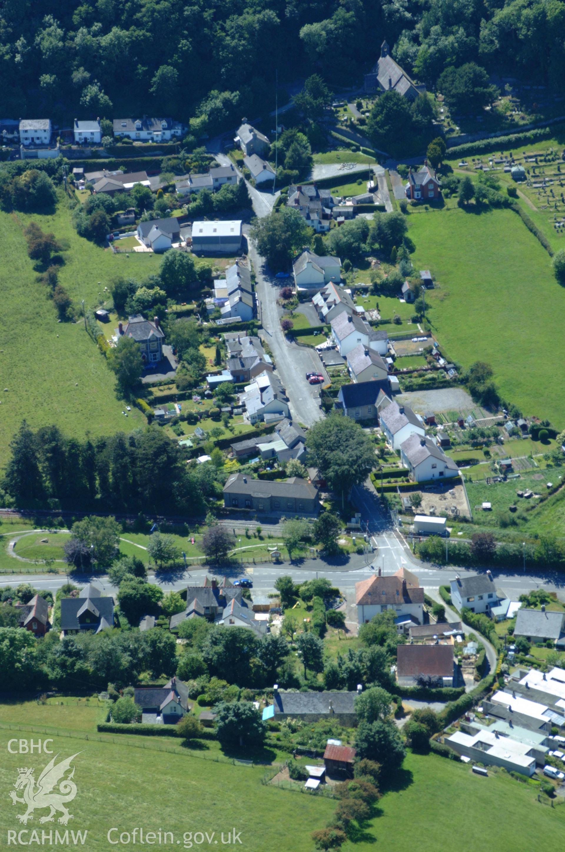 RCAHMW colour oblique aerial photograph of Llanfihangel Railway Station and village. Taken on 14 June 2004 by Toby Driver