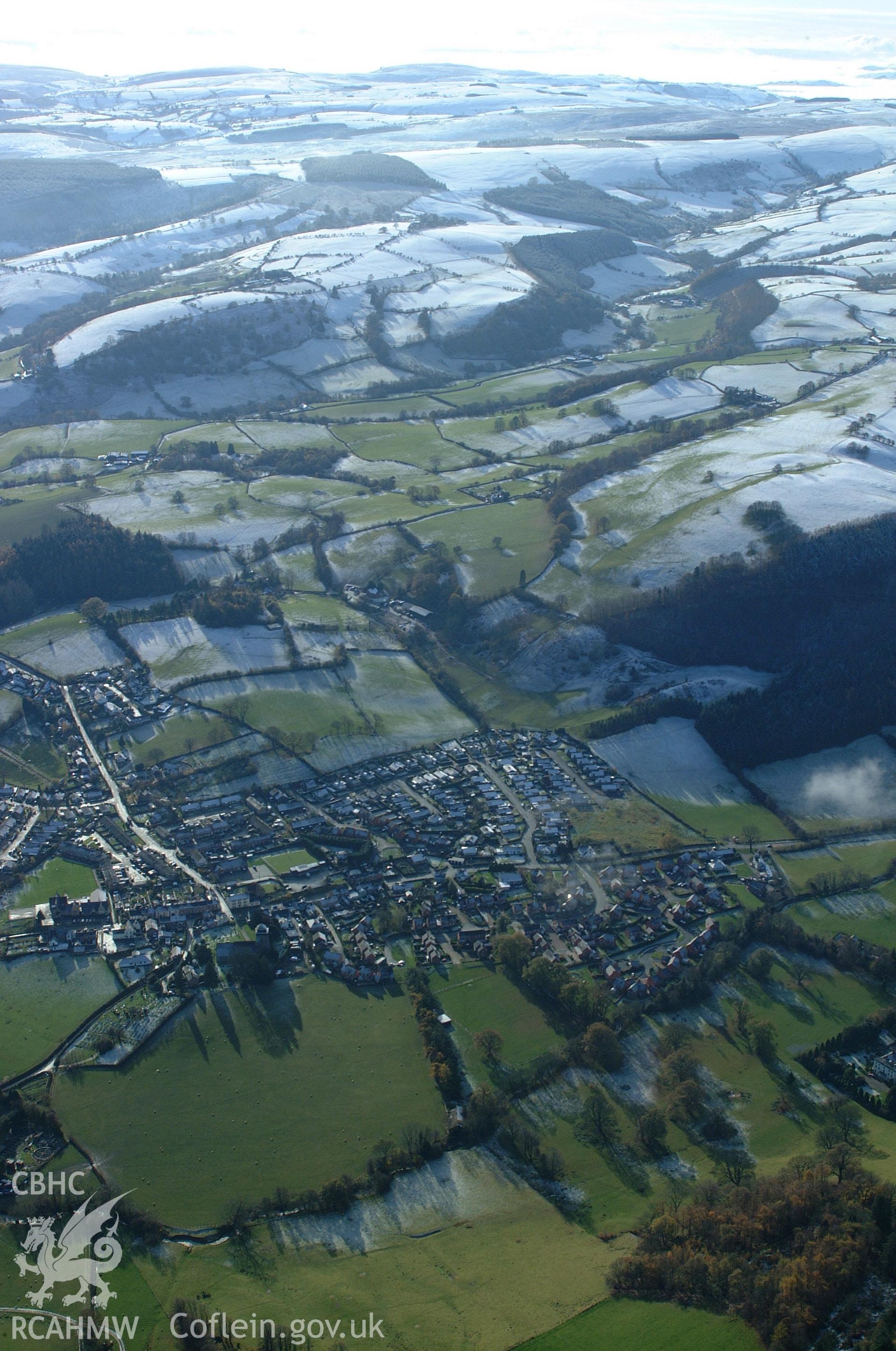 RCAHMW colour oblique aerial photograph of Moat Castle, Kerry and village in winter view from the north. Taken on 19 November 2004 by Toby Driver