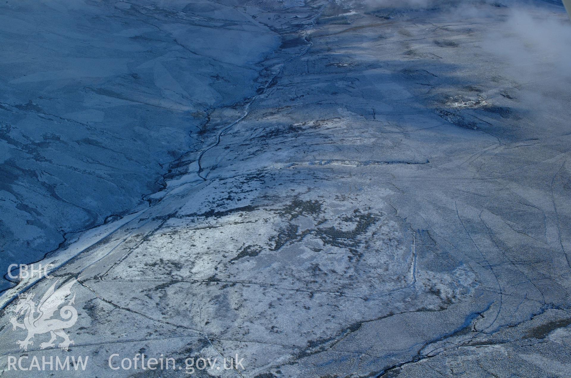 RCAHMW colour oblique aerial photograph of Pen Plaenau Roman Marching Camp, viewed from the east, under snow. Taken on 19 November 2004 by Toby Driver