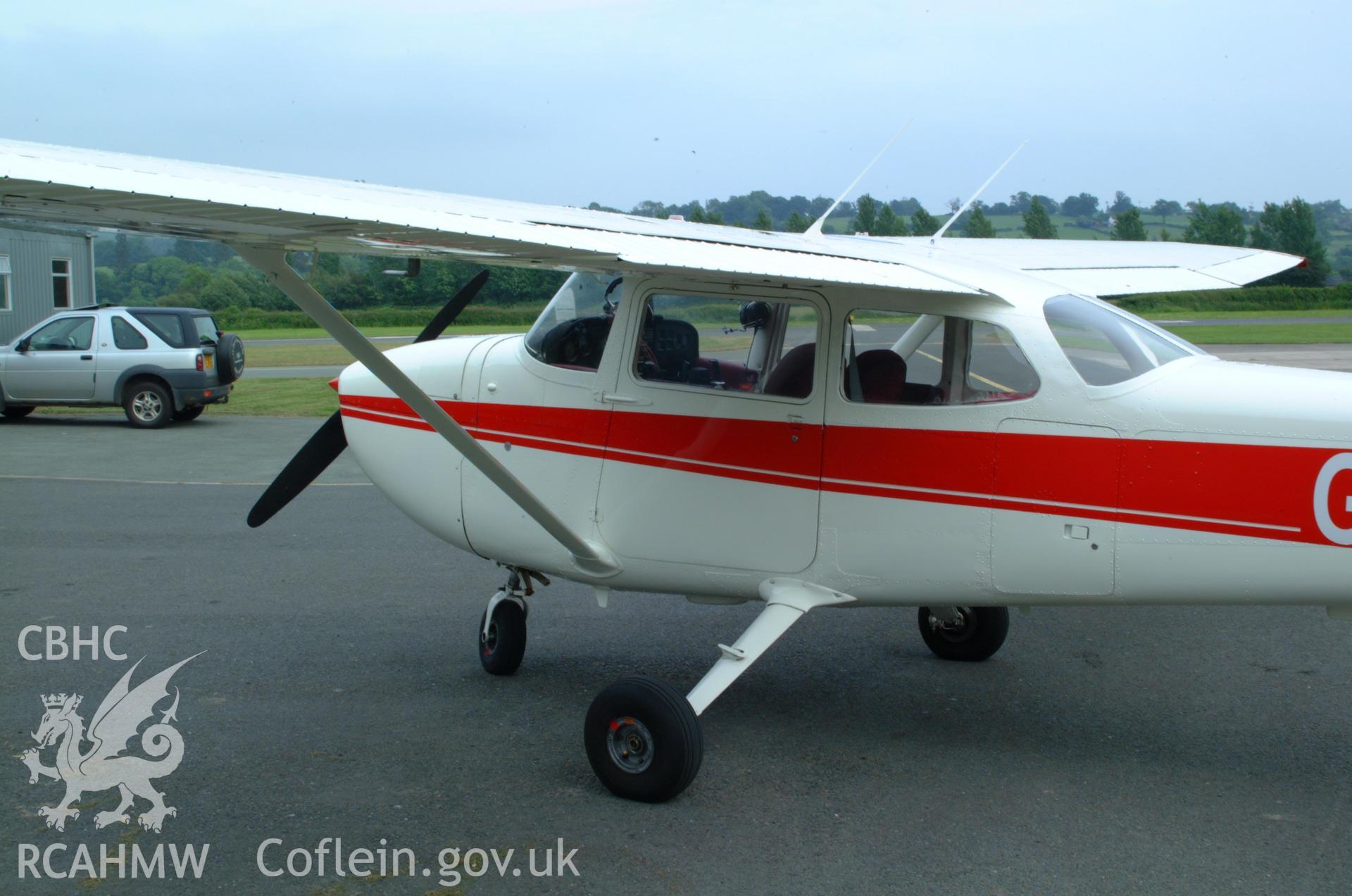 RCAHMW colour oblique aerial photograph of Montgomeryshire Mid Wales Airport, views of aircraft for lecture purposes Taken on 08 June 2004 by Toby Driver