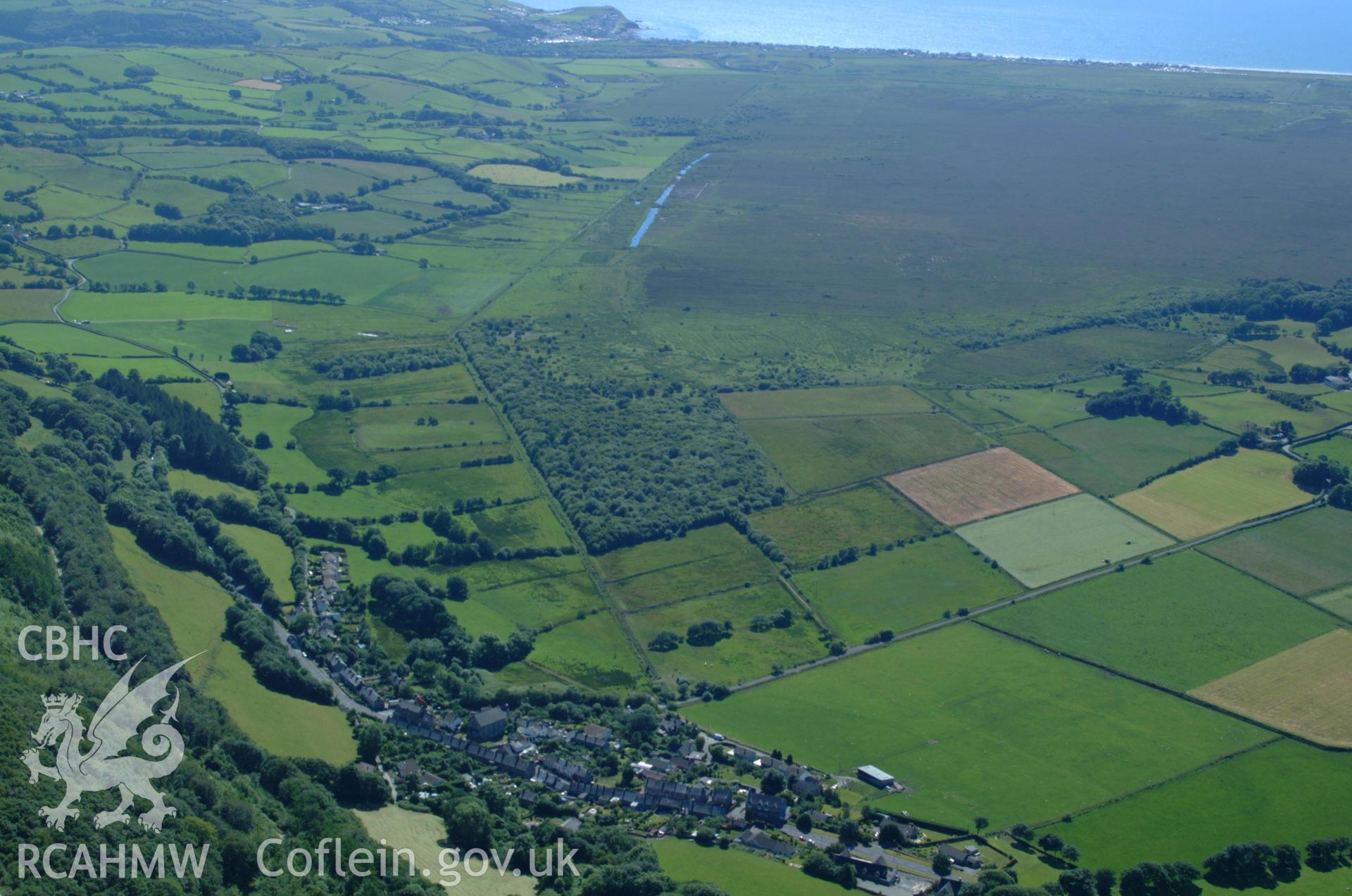 RCAHMW colour oblique aerial photograph of Tre Taliesin Village taken on 14/06/2004 by Toby Driver