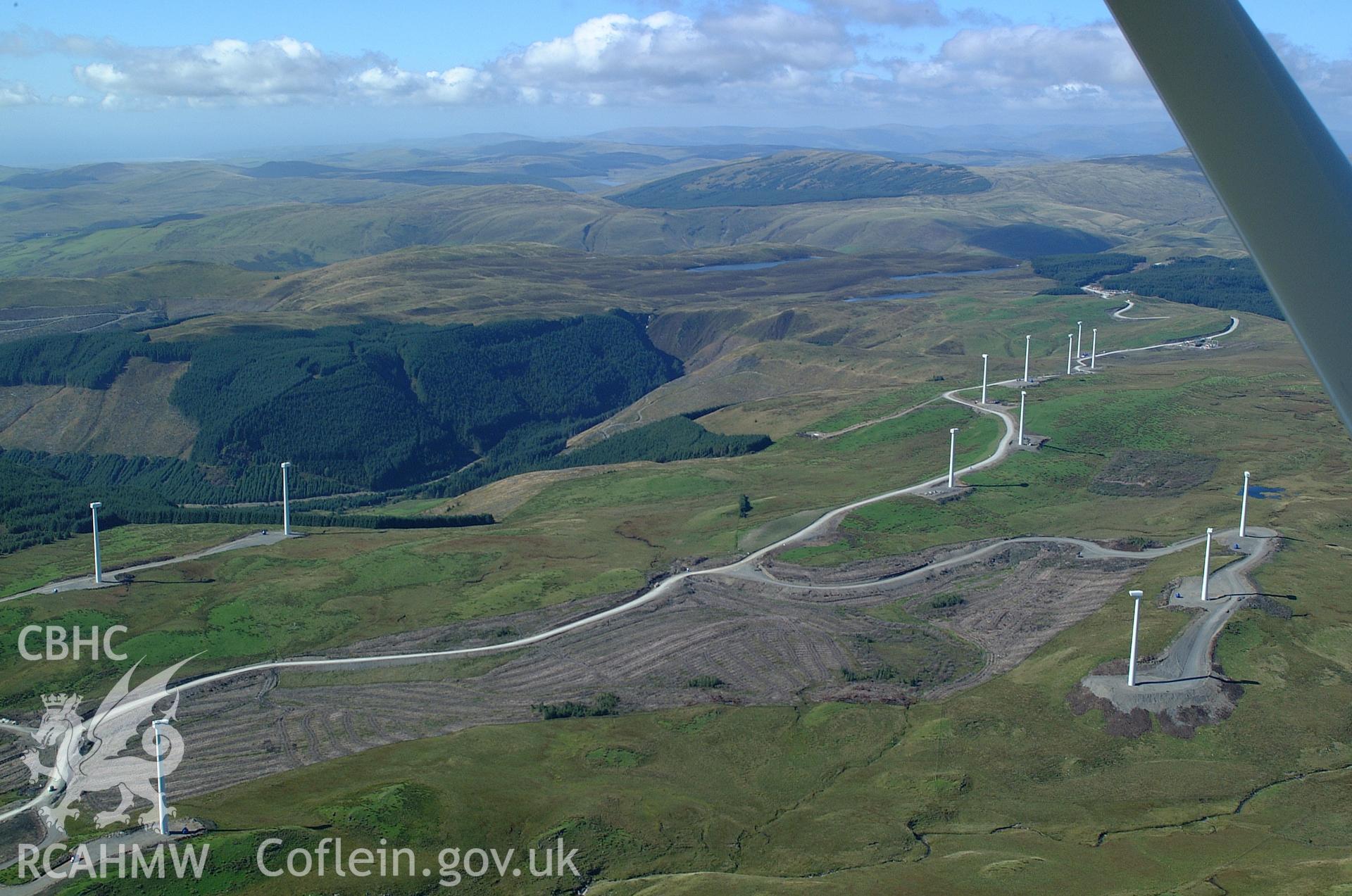 RCAHMW colour oblique aerial photograph of Cefn Croes Wind Farm during construction, looking north-west. Taken on 31 August 2004 by Toby Driver