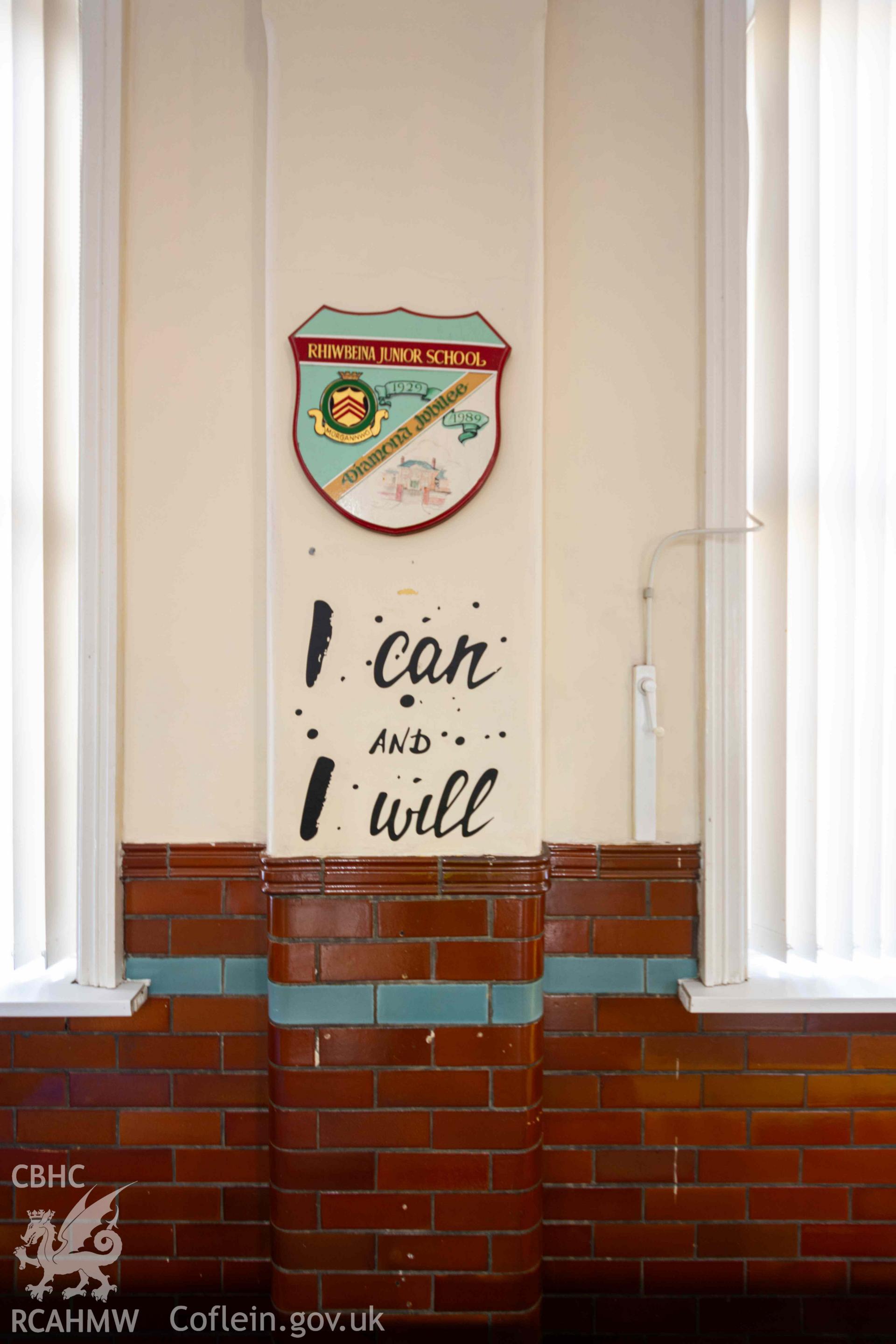 I can and I will' motto and school badge on assembly hall pilaster. Rhiwbeina Primary School