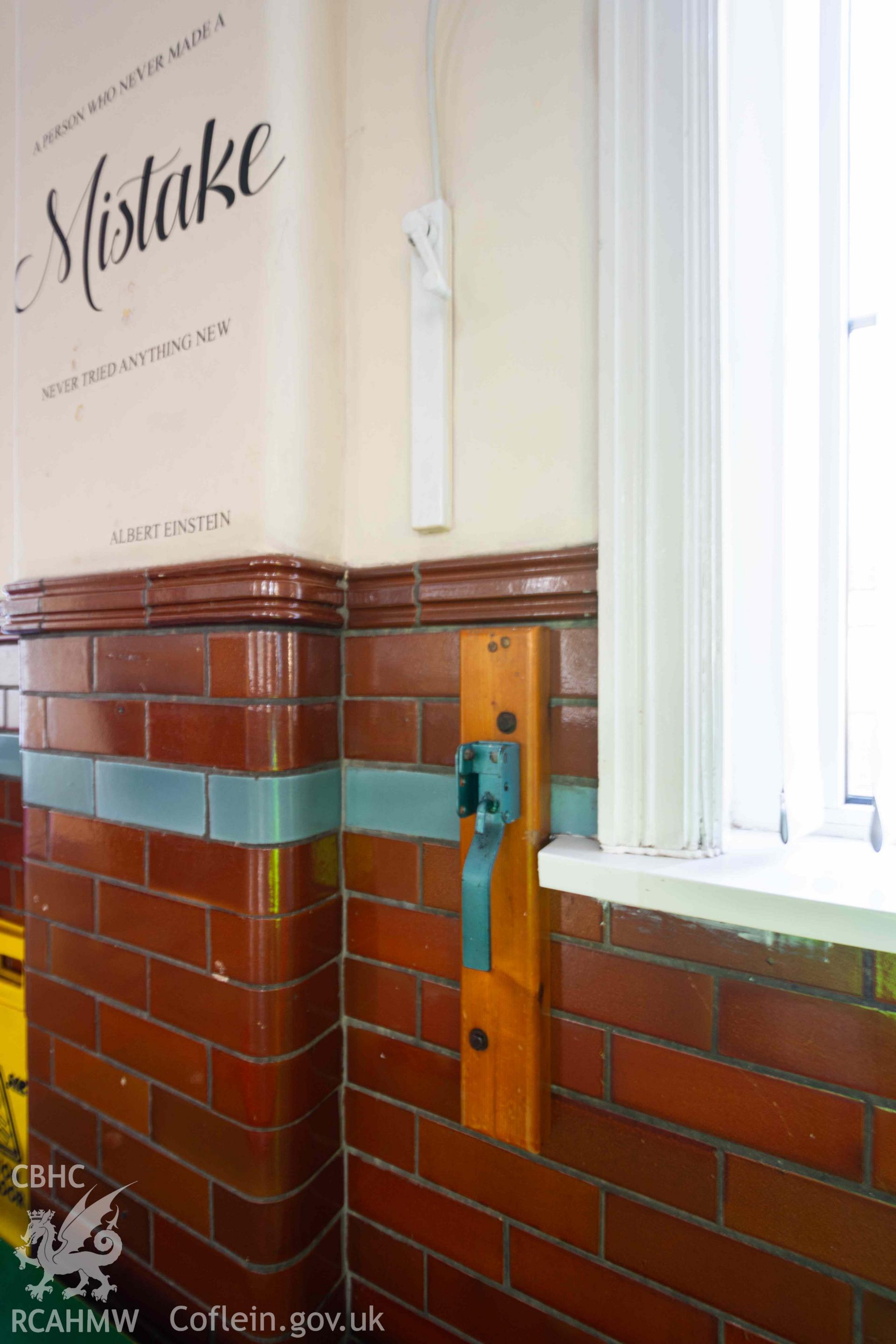Tiles detail and Albert Einstein quote on pilaster, assembly hall. Rhiwbeina Primary School