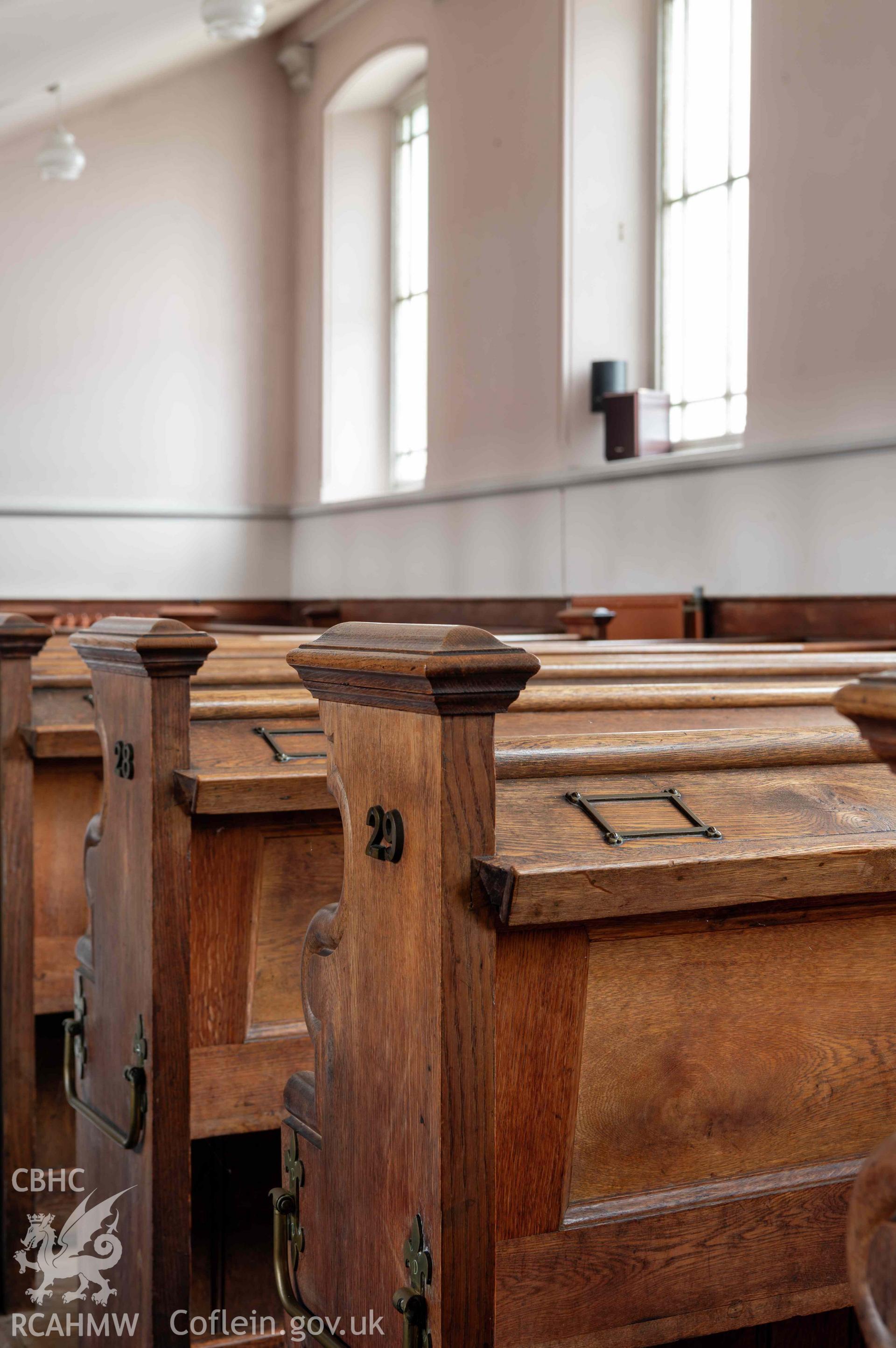 Capel Zion Baptist Chapel, Newtown - auditorium, detail of pew ends to eastern bank of pews.