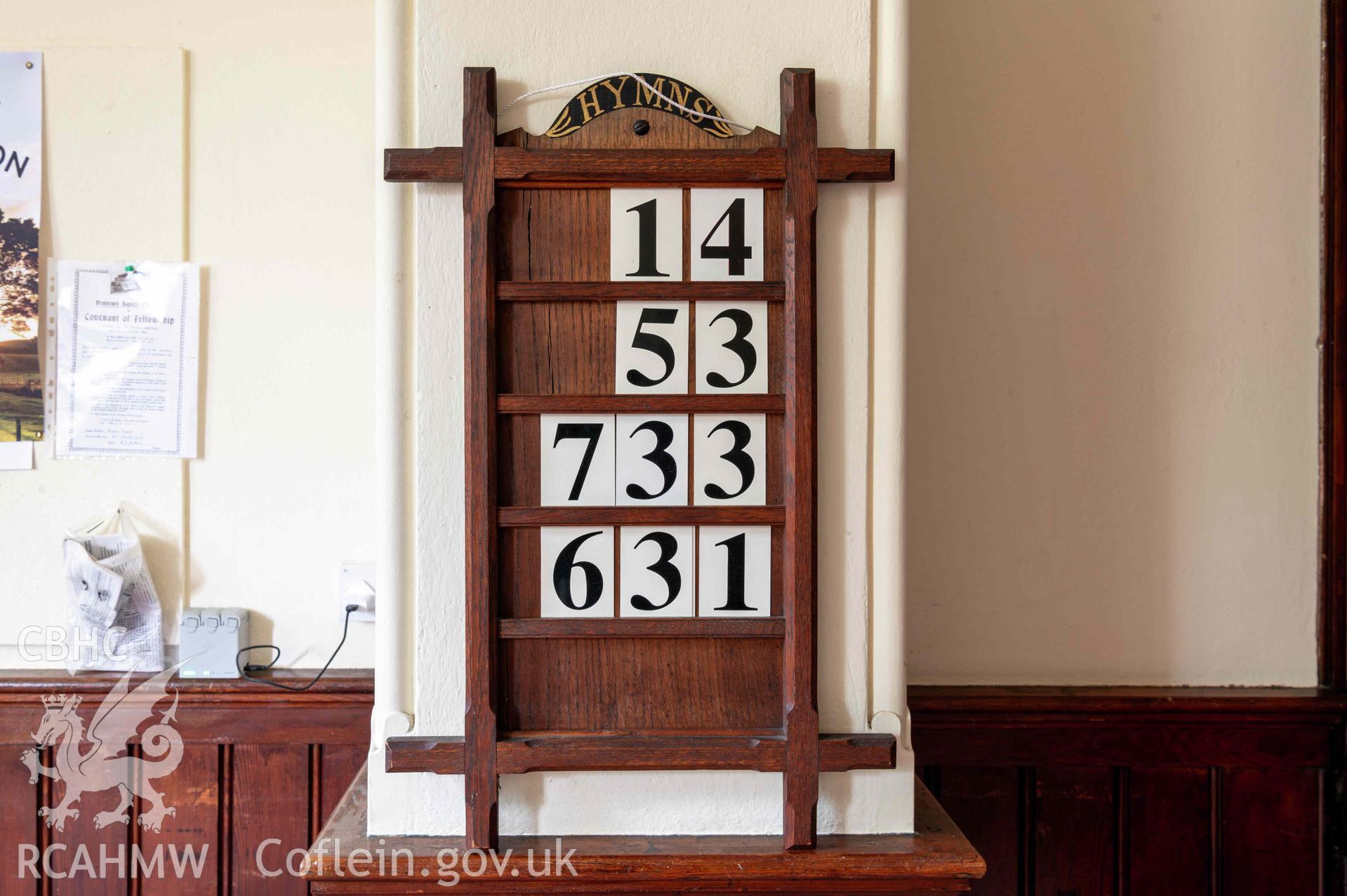 Capel Zion Baptist Chapel, Newtown - north-central basement room detail of hymn board.