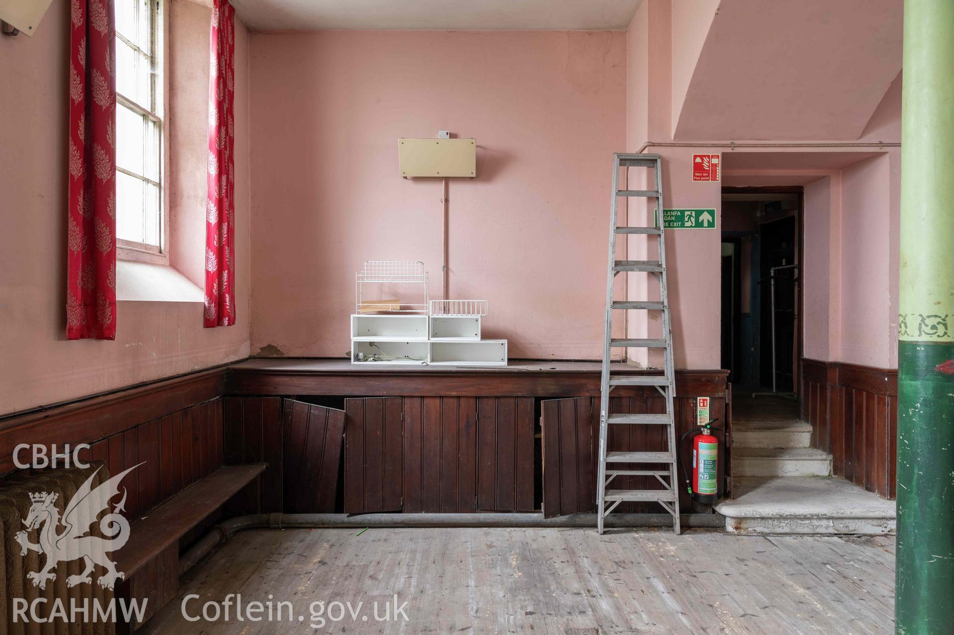 Capel Zion Baptist Chapel, Newtown - basement schoolroom, detail of south-eastern corner with boarded cupboards.