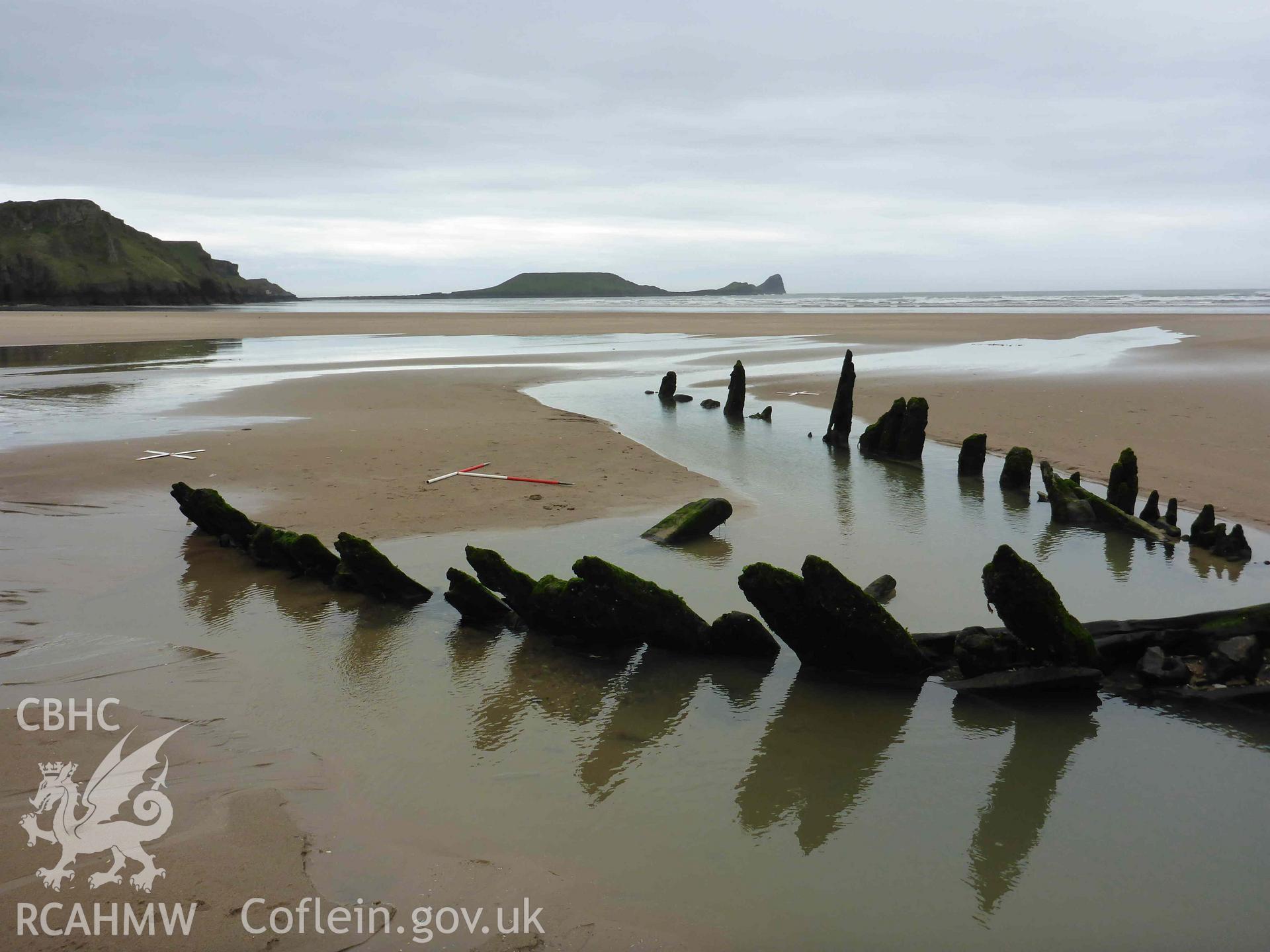 Exposed frames of the wreck of the HELVETIA, looking southwest towards Worms Head. Scales are 1m. Photographed as part of a digital photographic survey conducted by Julian Whitewright on 8 April 2024.