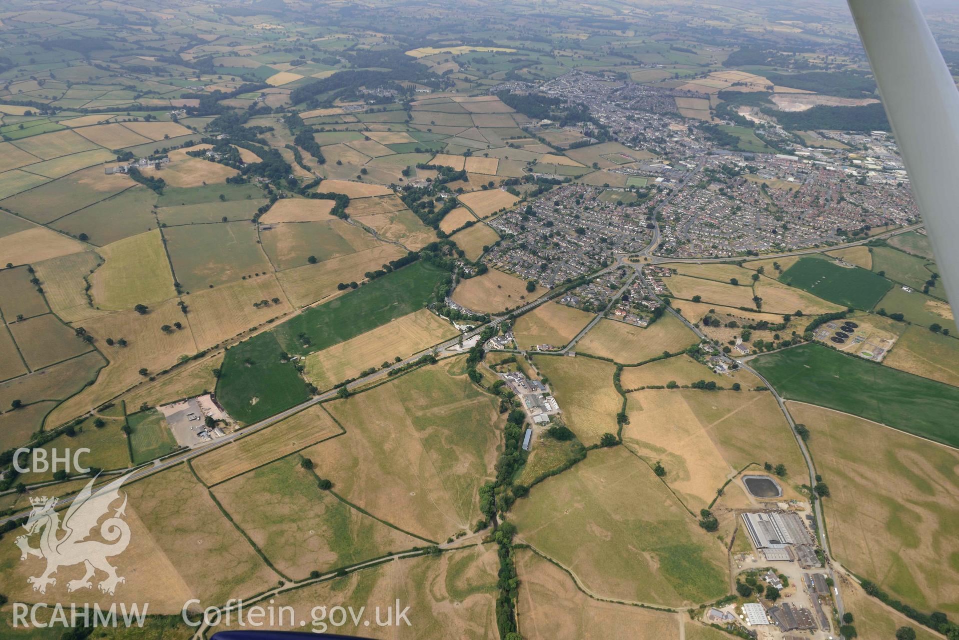 Denbigh Town with cropmarks from the south east. Oblique aerial photograph taken during the Royal Commission’s programme of archaeological aerial reconnaissance by Toby Driver on 10 July 2018.