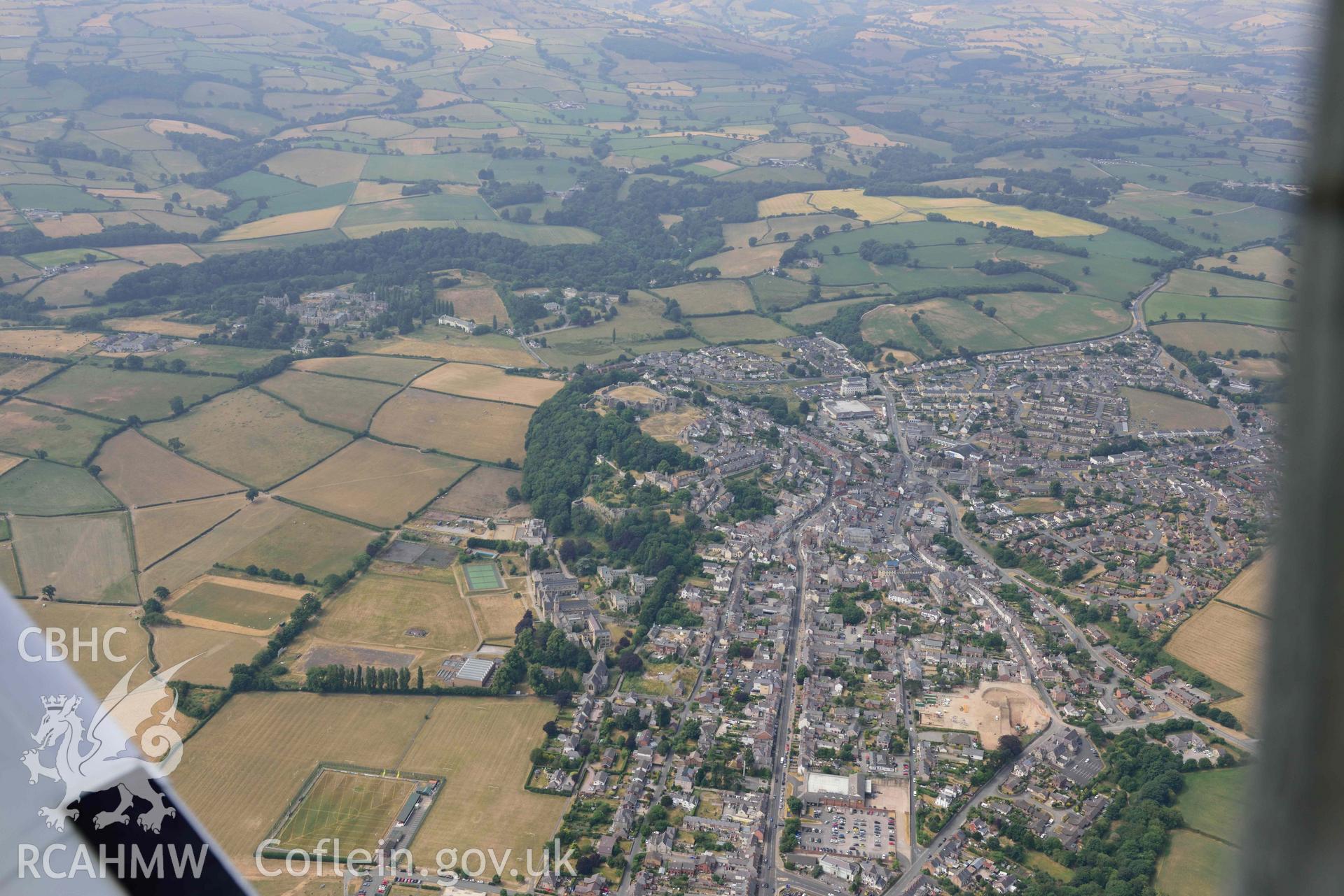 Denbigh Town with cropmarks from the south east. Oblique aerial photograph taken during the Royal Commission’s programme of archaeological aerial reconnaissance by Toby Driver on 10 July 2018.