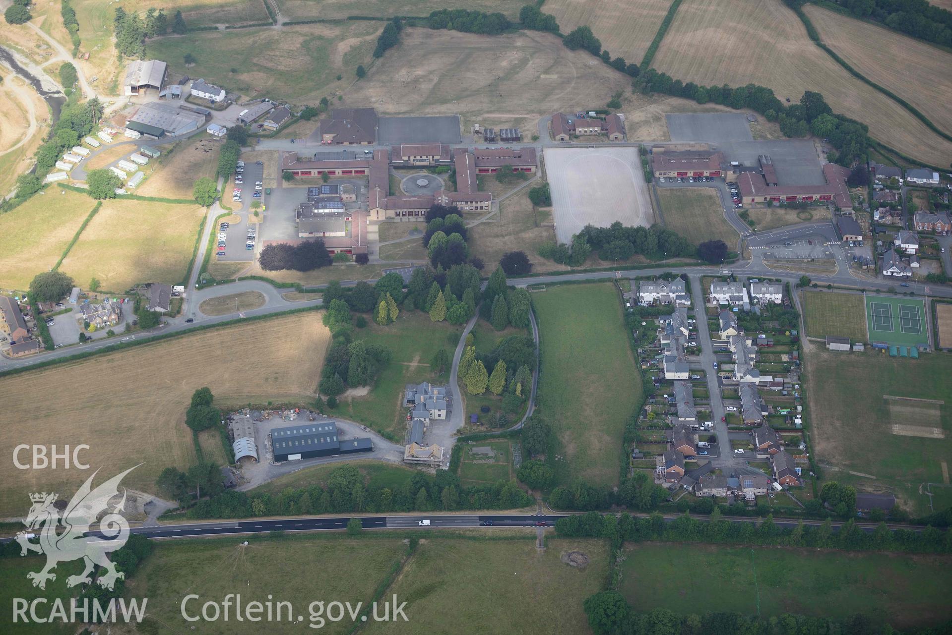 Llanidloes high school with parching. Oblique aerial photograph taken during the Royal Commission’s programme of archaeological aerial reconnaissance by Toby Driver on 10 July 2018.