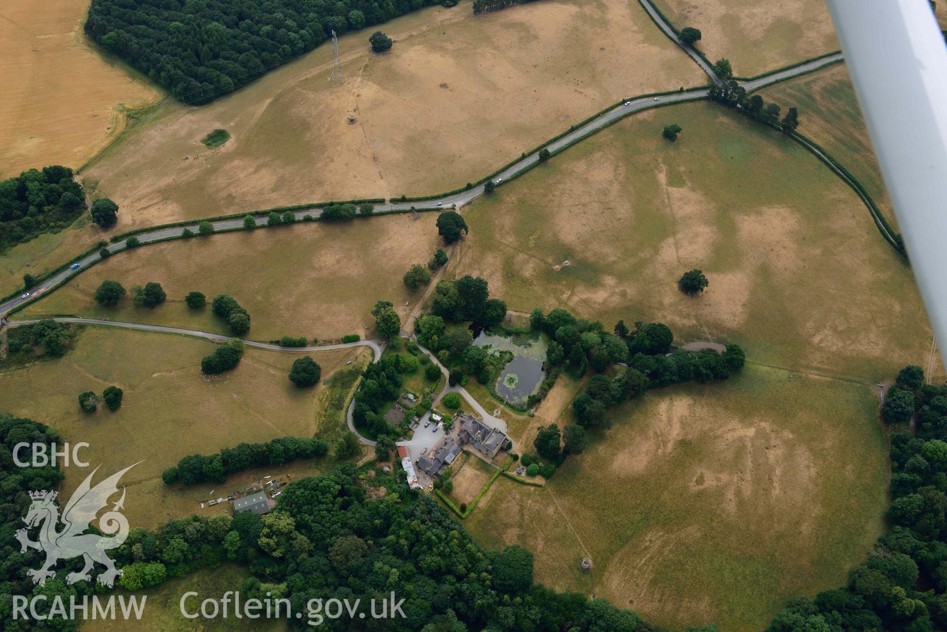 Cropmarks at Tower Garden, Mold. Oblique aerial photograph taken during the Royal Commission’s programme of archaeological aerial reconnaissance by Toby Driver on 10 July 2018.