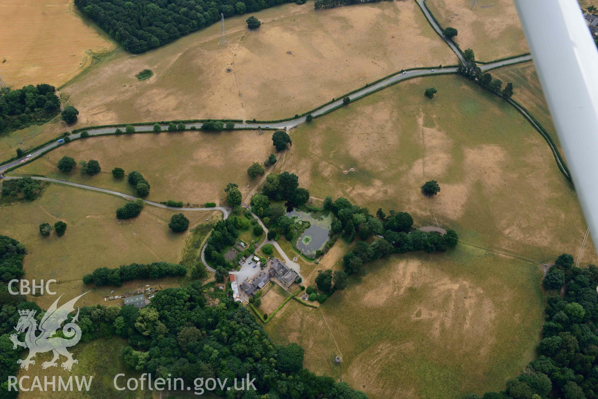 Cropmarks at Tower Garden, Mold. Oblique aerial photograph taken during the Royal Commission’s programme of archaeological aerial reconnaissance by Toby Driver on 10 July 2018.