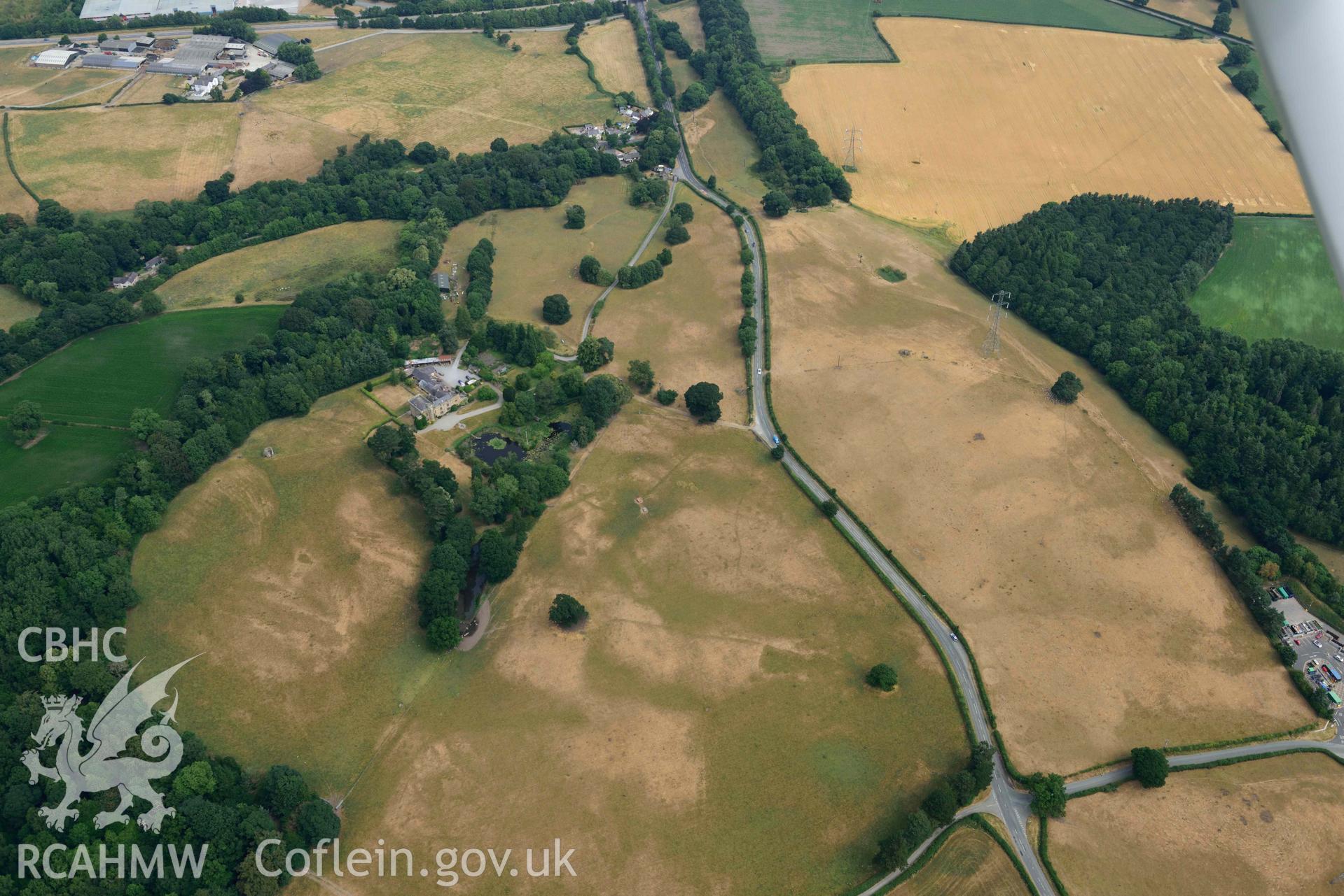 Cropmarks at Tower Garden, Mold. Oblique aerial photograph taken during the Royal Commission’s programme of archaeological aerial reconnaissance by Toby Driver on 10 July 2018.