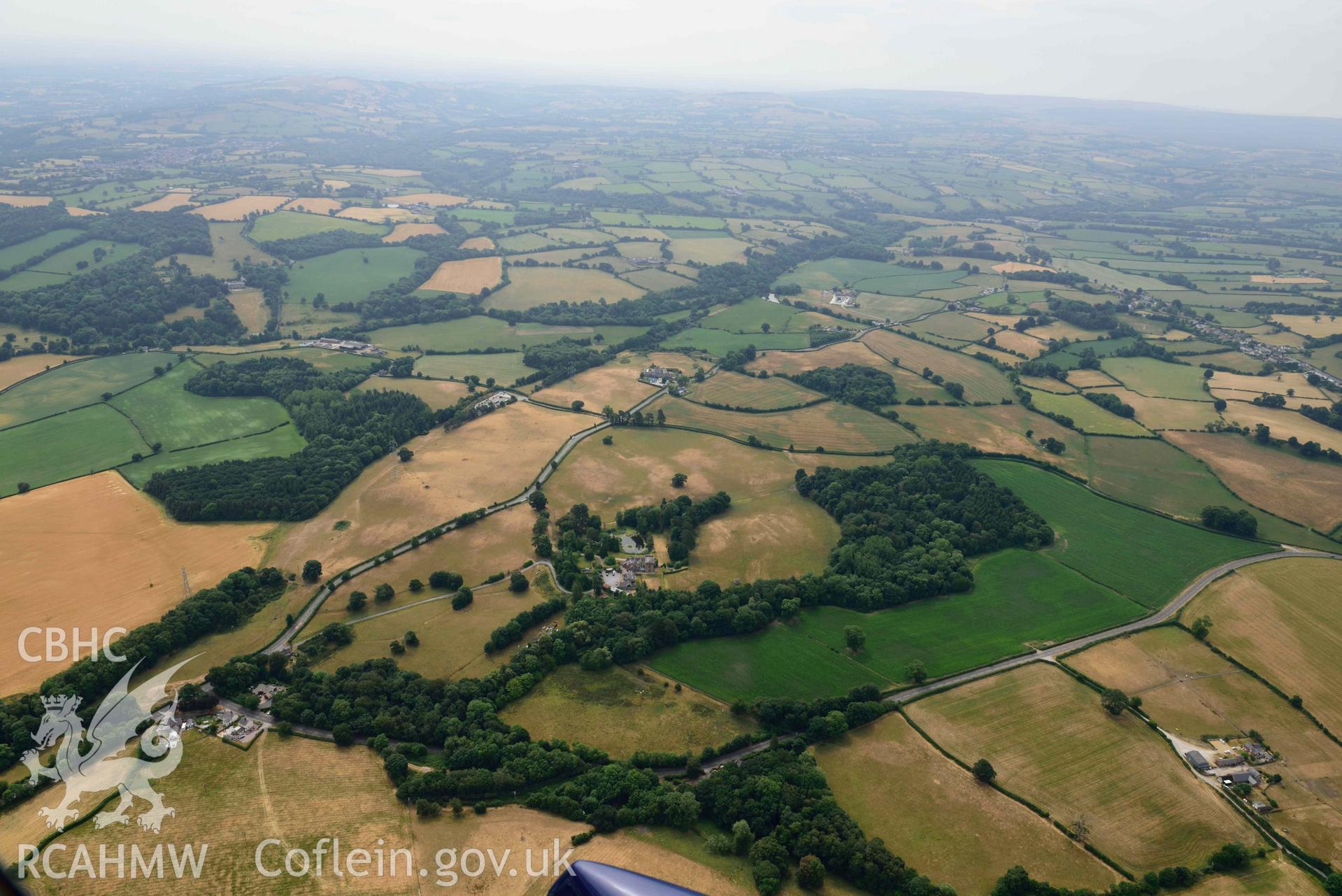 Cropmarks at Tower Garden, Mold. Oblique aerial photograph taken during the Royal Commission’s programme of archaeological aerial reconnaissance by Toby Driver on 10 July 2018.