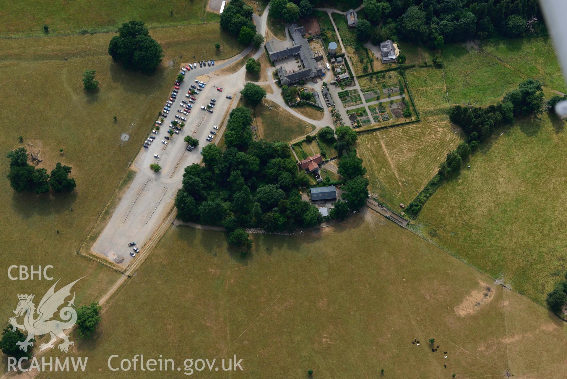 Car park and farm buildings at Chirk Castle. Oblique aerial photograph taken during the Royal Commission’s programme of archaeological aerial reconnaissance by Toby Driver on 10 July 2018.