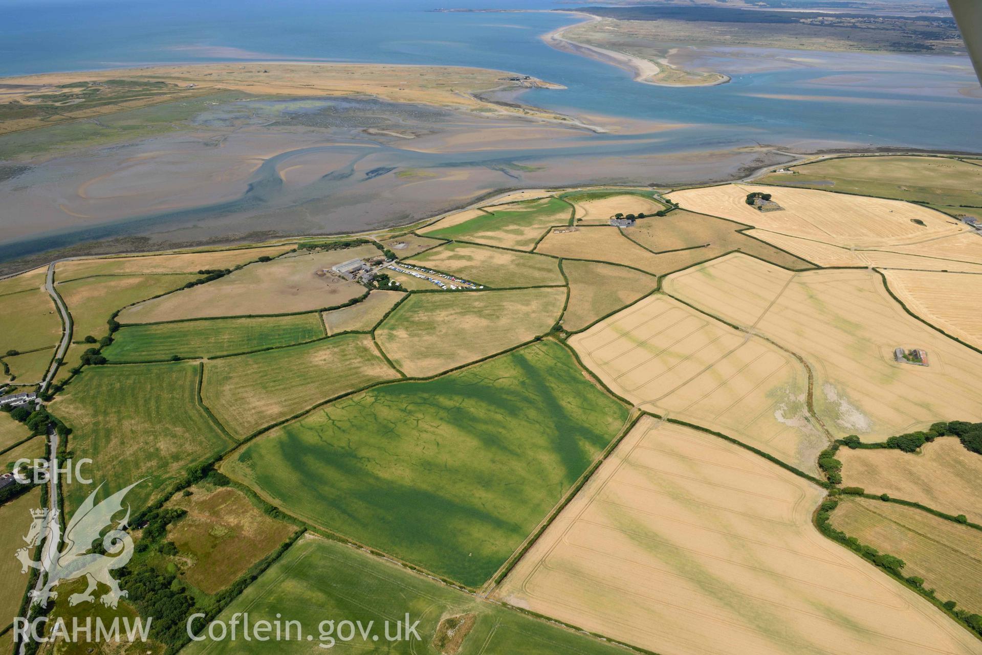 Rhostryfan cropmarks. Oblique aerial photograph taken during the Royal Commission’s programme of archaeological aerial reconnaissance by Toby Driver on 10 July 2018.