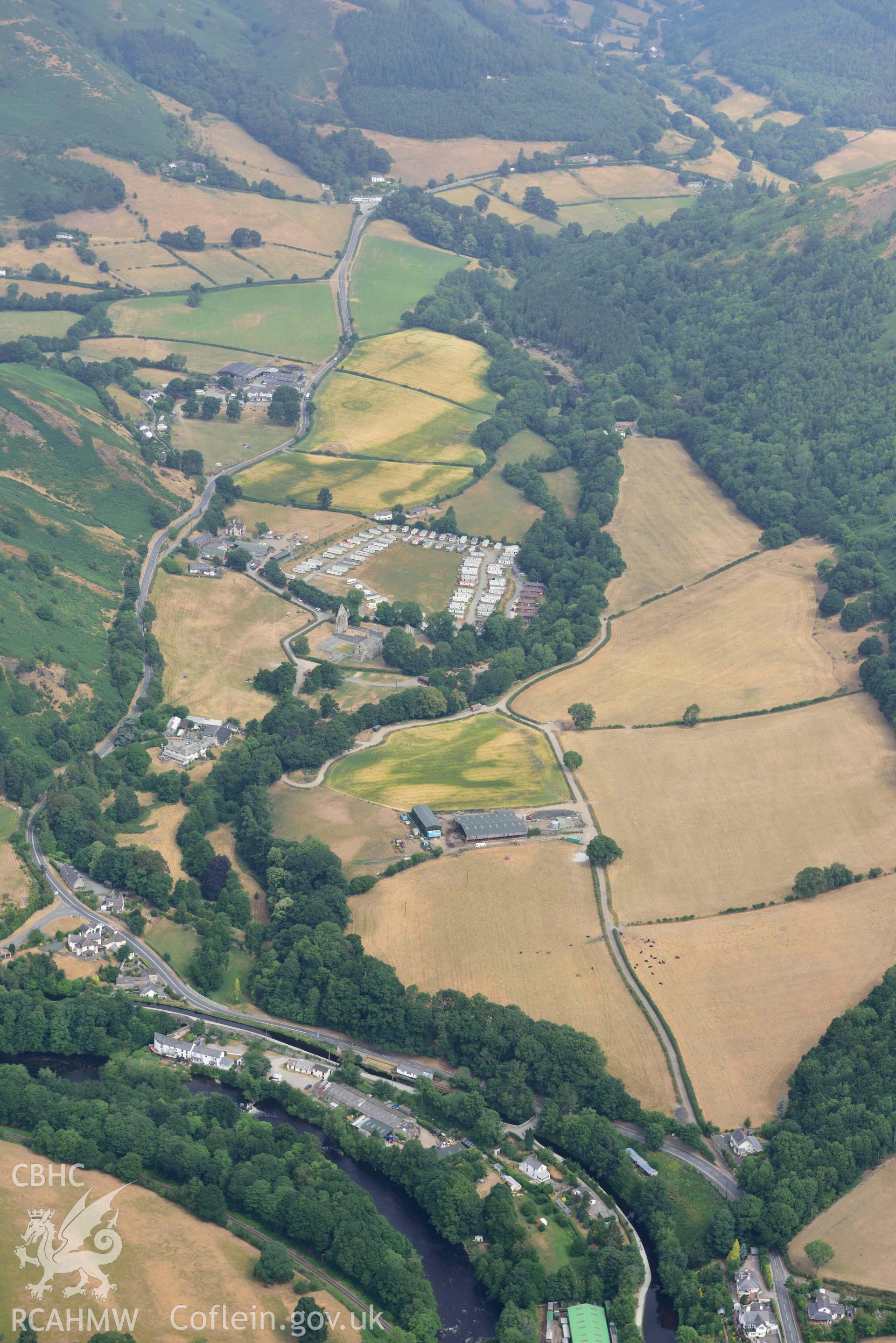 Vale Crucis Abbey and the Pillar of Eliseg. Oblique aerial photograph taken during the Royal Commission’s programme of archaeological aerial reconnaissance by Toby Driver on 10 July 2018.