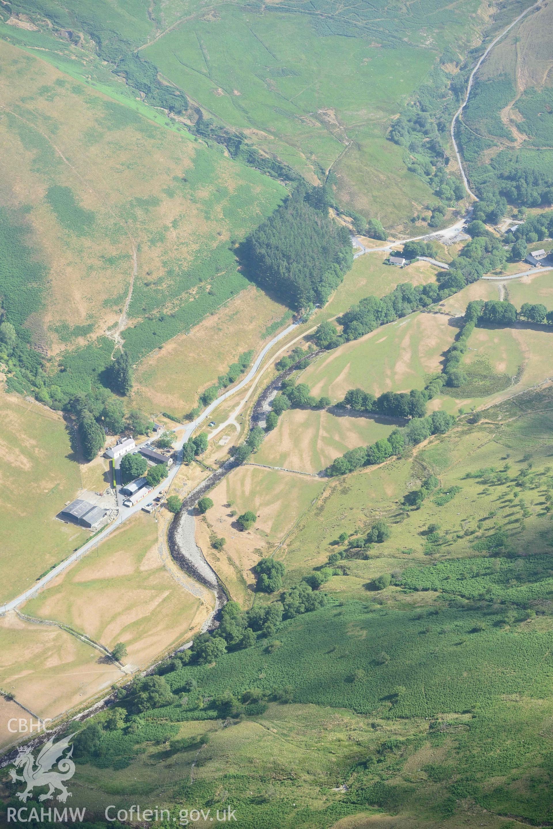 Valley parchmarks with Tyllwyd Cwmystwyth ring ditch and the site of Blaen Cwm chapel. Oblique aerial photograph taken during the Royal Commission’s programme of archaeological aerial reconnaissance by Toby Driver on 10 July 2018.