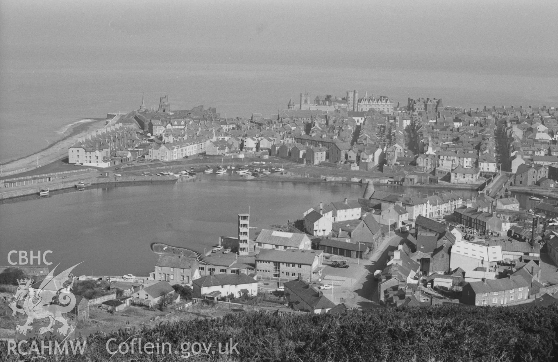 Digital copy of a black and white negative showing view of Aberystwyth harbour and town, and Trefechan, from the north end of Pendinas. Firestation in centre of image. Photographed by Arthur Chater on 3 April 1969. Looking north from Grid Reference SN 5832 8079.