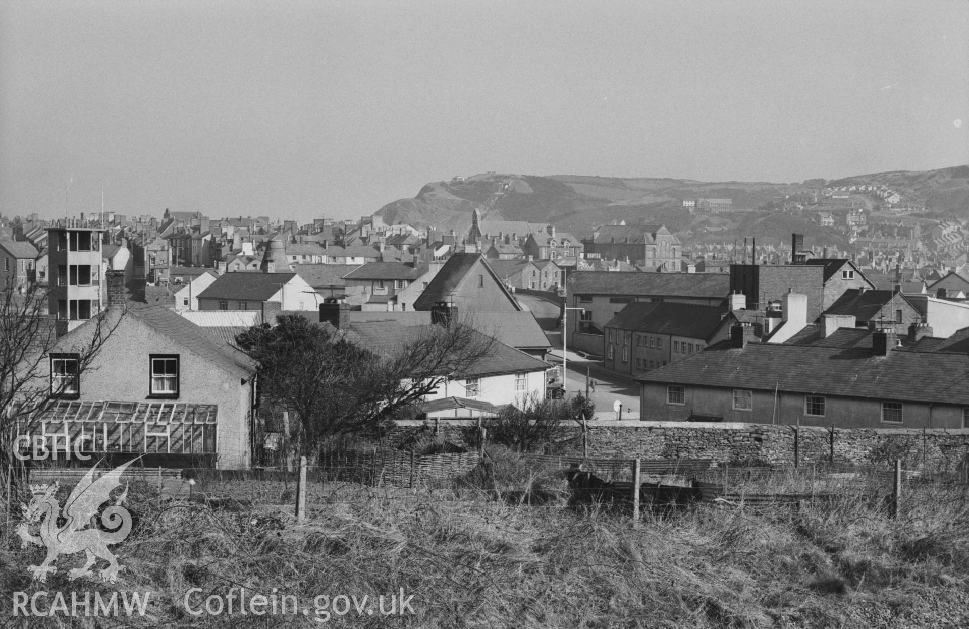 Digital copy of a black and white negative showing Trefechan and Aberystwyth from the railway 100m west south west of the railway bridge at the bottom of Penparcau Road. Photographed by Arthur Chater on 3 April 1969. Looking north from Grid Reference SN 58225 80990.