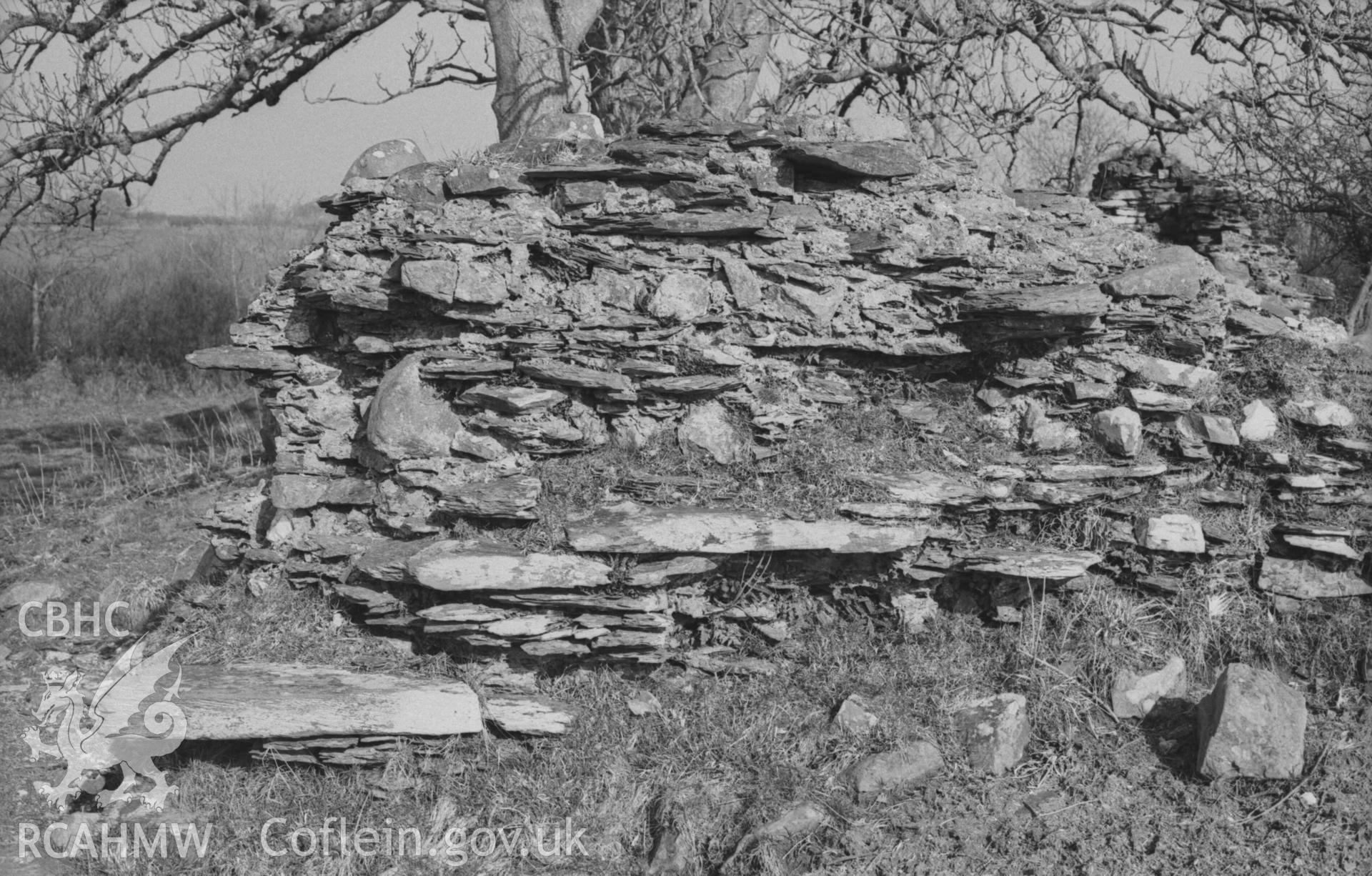 Digital copy of a black and white negative showing outside of north western corner of the ruin of Llanfairtrefhelygen church. Photographed by Arthur Chater on 5 April 1969. Looking east from Grid Reference SN 3437 4414.