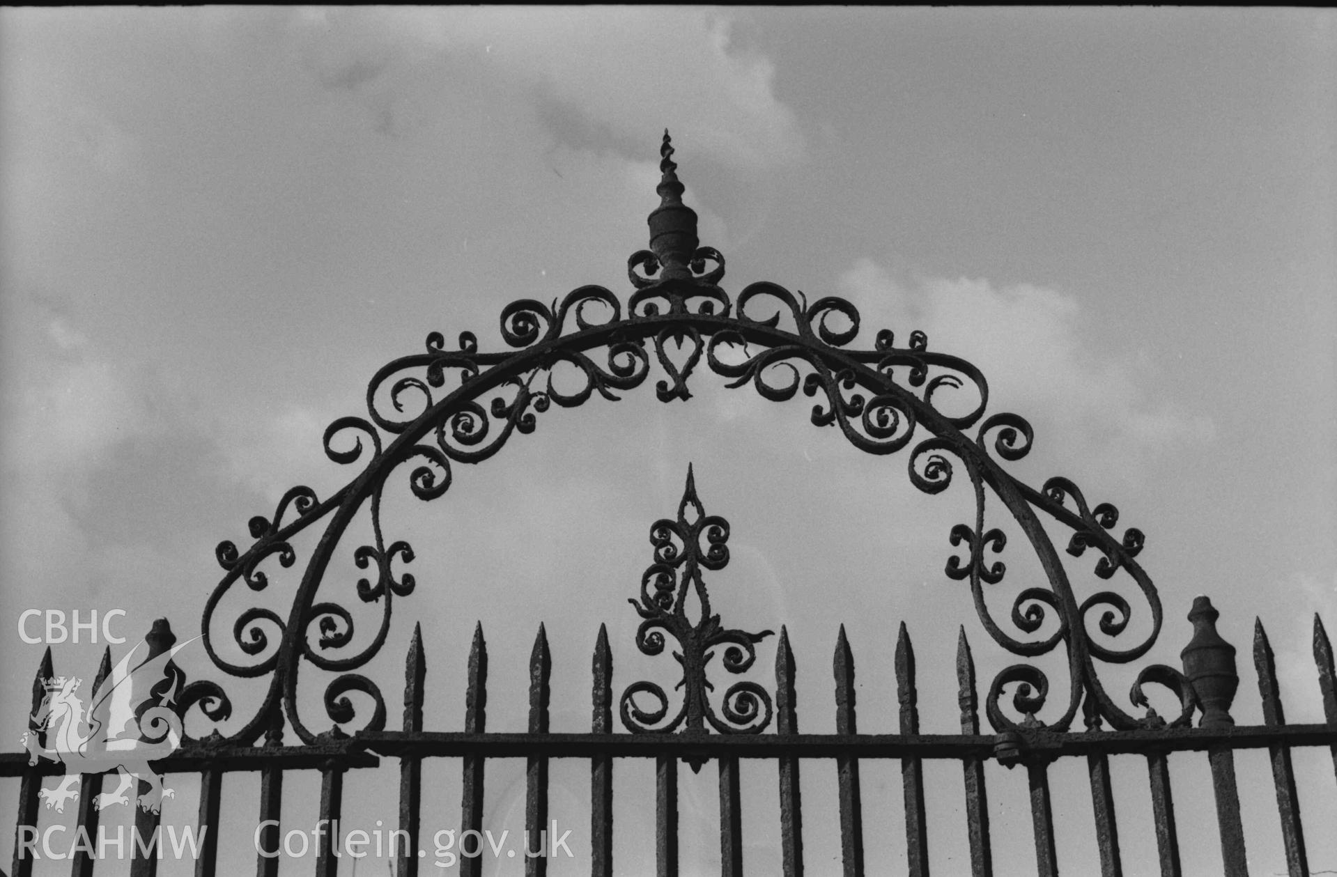 Digital copy of a black and white negative showing detail view of wrought iron grace enclosure at the north west corner of St Cynllo's churchyard, containing the graves of Lt.-Col Herbert Rhys,  J.O.D.; Rhys Jones Lloyd, b. 1827, d. 1889. Photographed by Arthur Chater on 7 April 1969. Looking north from Grid Reference SN 1993 4580.