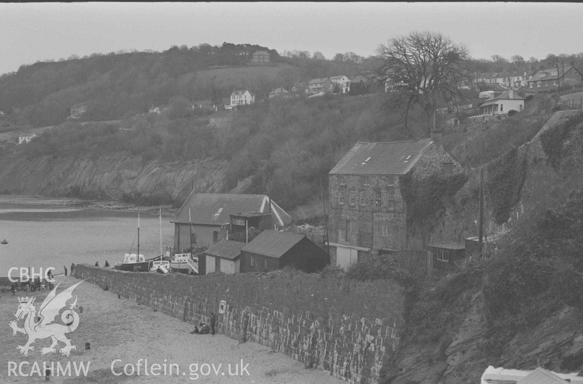 Digital copy of a black and white negative showing lifeboat station and older buildings from South John Street; Pen-Rhiw in centre on the skyline. Photographed by Arthur Chater on 9 April 1969. Looking south from Grid Reference SN 3899 6000.