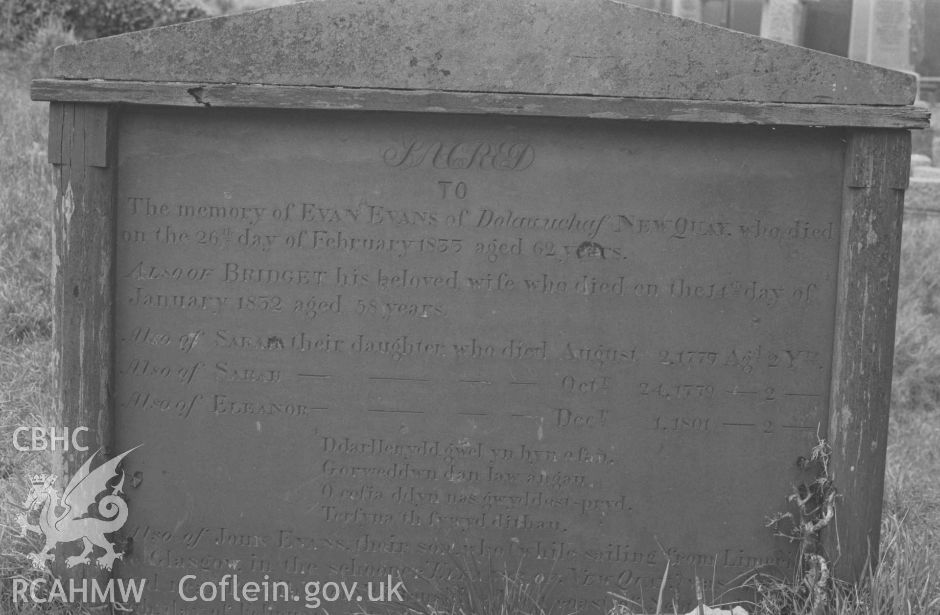 Digital copy of a black and white negative showing the Evans family of Dolau uchaf's gravestone at St Llwchaeran's Church yard, New Quay (near the north west end). Photographed by Arthur Chater on 9 April 1969. Grid Reference SN 3845 5992.