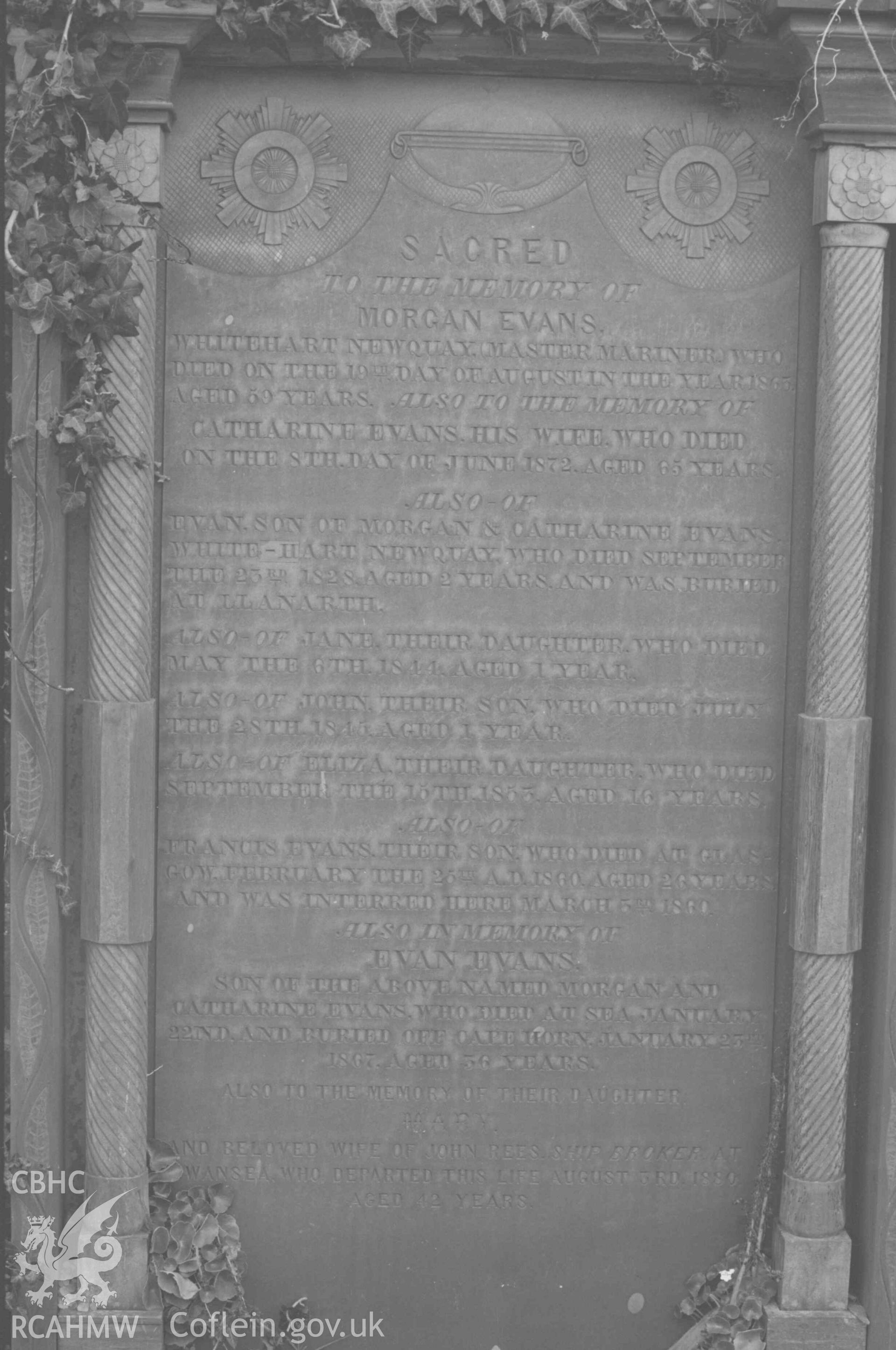 Digital copy of a black and white negative showing the Evans family of Whitehart, Newquay's gravestone at St Llwchaeran's Church yard, New Quay (near the north west end). Photographed by Arthur Chater on 9 April 1969. Grid Reference SN 3845 5992.