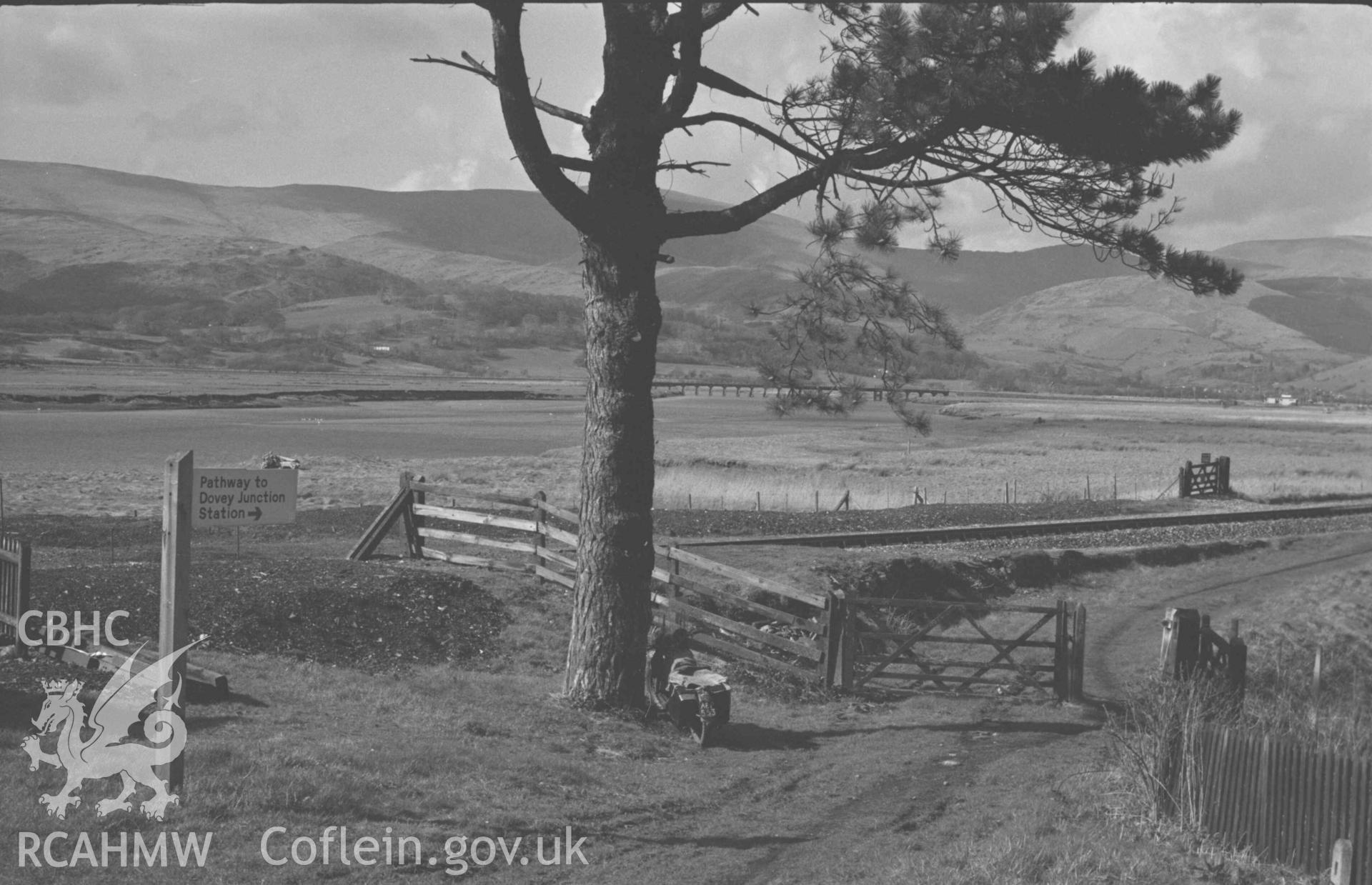 Digital copy of a black and white negative showing the Dyfi and Glandyfi Station from the north east. Photographed by Arthur Chater on 12 April 1969. Looking north from Grid Reference SN 6955 9697.