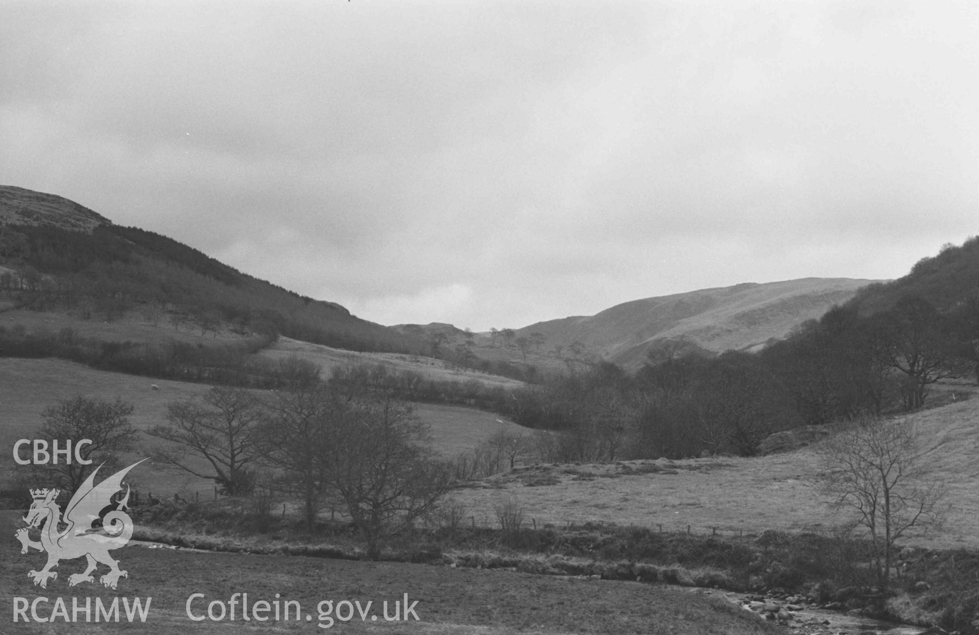Digital copy of a black and white negative showing view looking up Cwm Ty-Nant (valley of Afon Cyneiniog) from outside Glan-Aber by Capel Bethesda. Photographed by Arthur Chater on 13 April 1969. Looking east south east from Grid Reference SN 6942 8851.