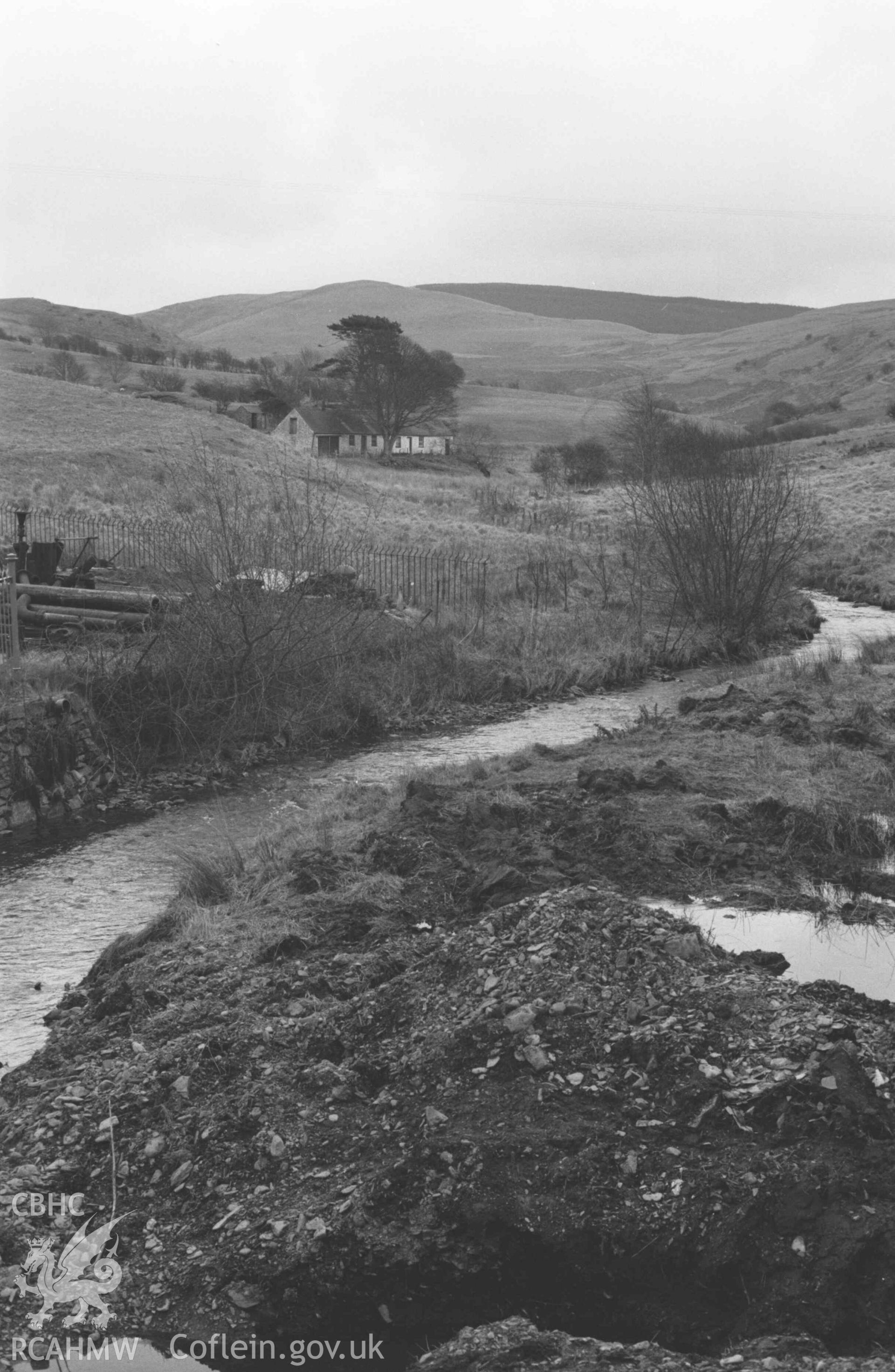 Digital copy of a black and white negative showing view to Llyn-Crew Cottages from the bridge (Bont Goch) over the Leri in Elerch. Photographed by Arthur Chater on 13 April 1969. Looking south east from Grid Reference SN 6837 8622.