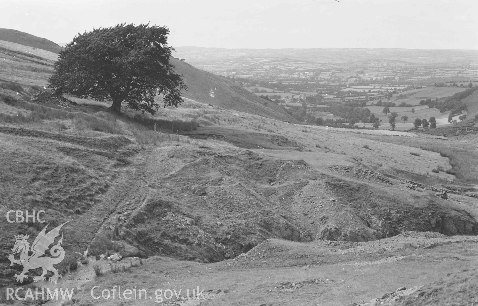 Digital copy of a black and white negative showing view down the Nant Rhysgog, over the lead mine. Photographed by Arthur Chater on 23 August 1969. Looking north west from Grid Reference SN 6815 5373.