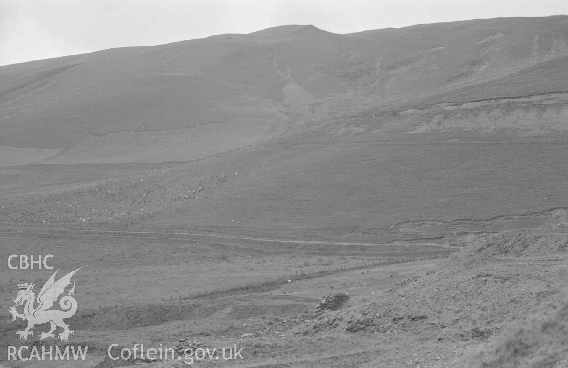 Digital copy of a black and white negative showing view down the Afon Castell from the lead mine, Llys-Arthur in centre; Gelli-Uchaf to the right. (Panorama, photograph 4 of 4). Photographed by Arthur Chater on 25 August 1969. Looking south west from Grid Reference SN 7912 8278.