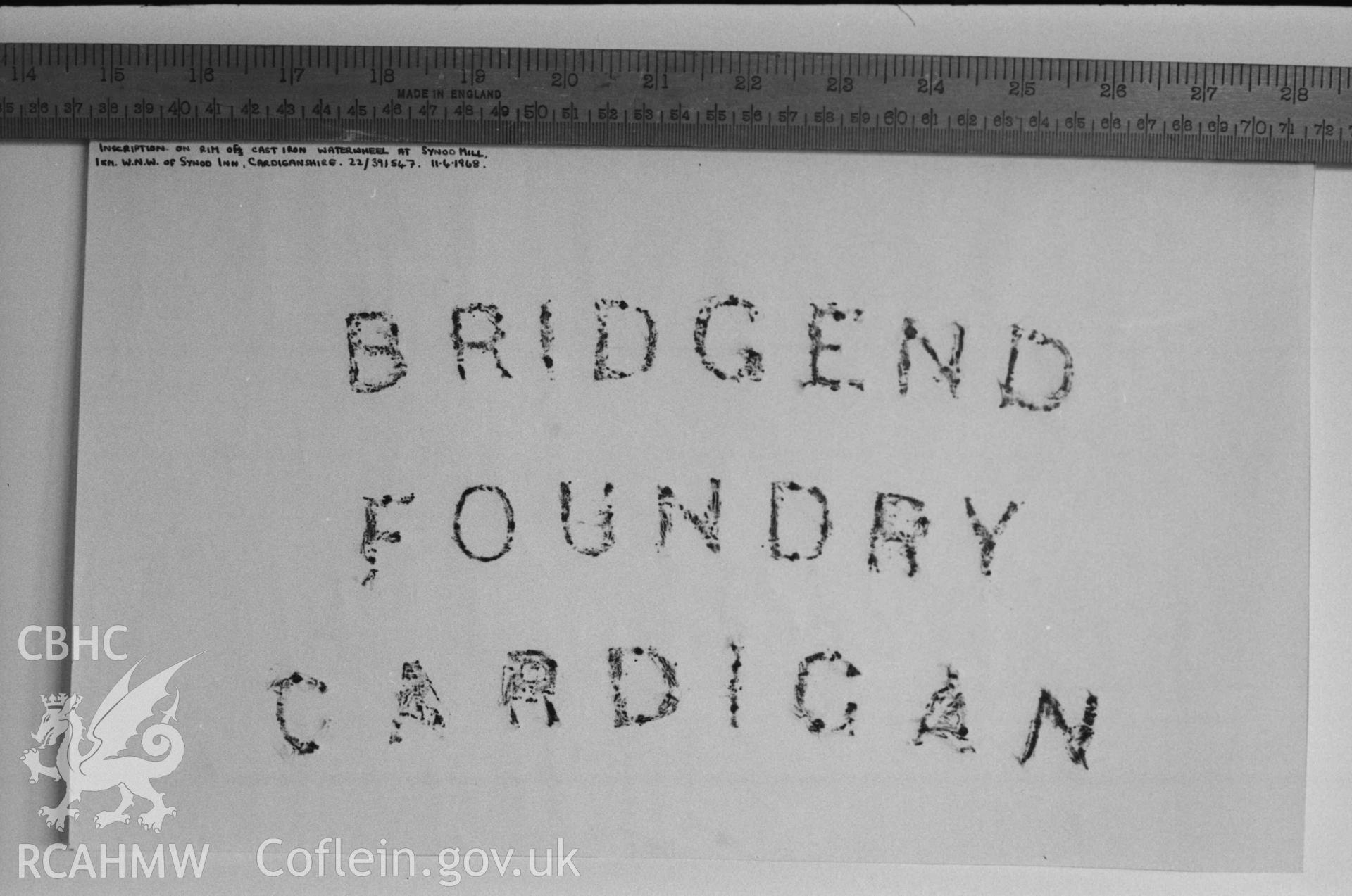 Digital copy of a black and white negative showing rubbing of inscription on rim of cast iron waterwheel at Melin Synod. Produced by Arthur Chater on 26 August 1969.