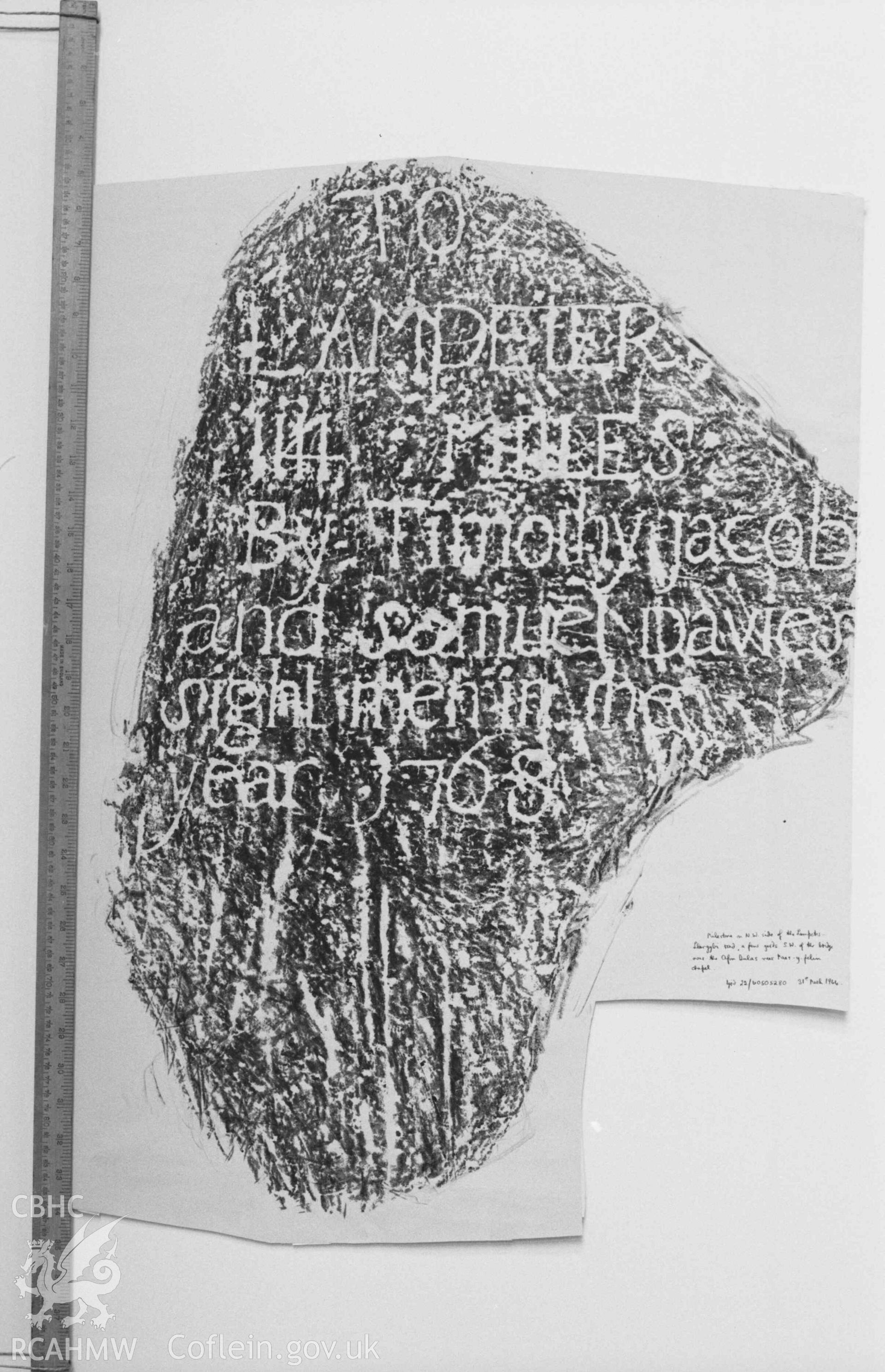 Digital copy of a black and white negative showing inscription on milestone on the north west side of the Lampeter-Llangybi road, a few yards south west of the bridge over the Afon Dulas near Pant-y-Felin chapel. Produced by Arthur Chater on 26 August 1969.