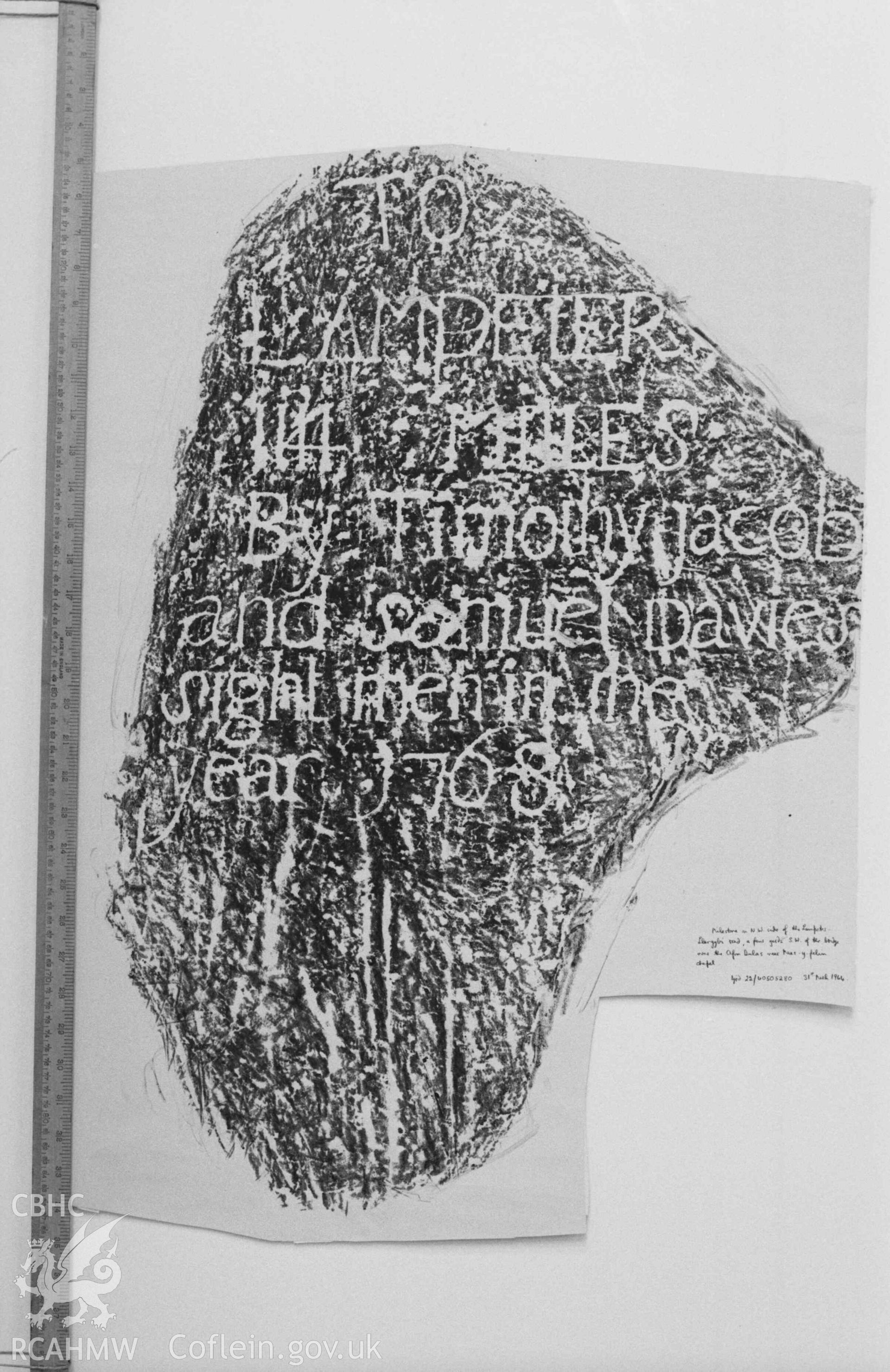 Digital copy of a black and white negative showing inscription on milestone on the north west side of the Lampeter-Llangybi road, a few yards south west of the bridge over the Afon Dulas near Pant-y-Felin chapel. Produced by Arthur Chater on 26 August 1969.