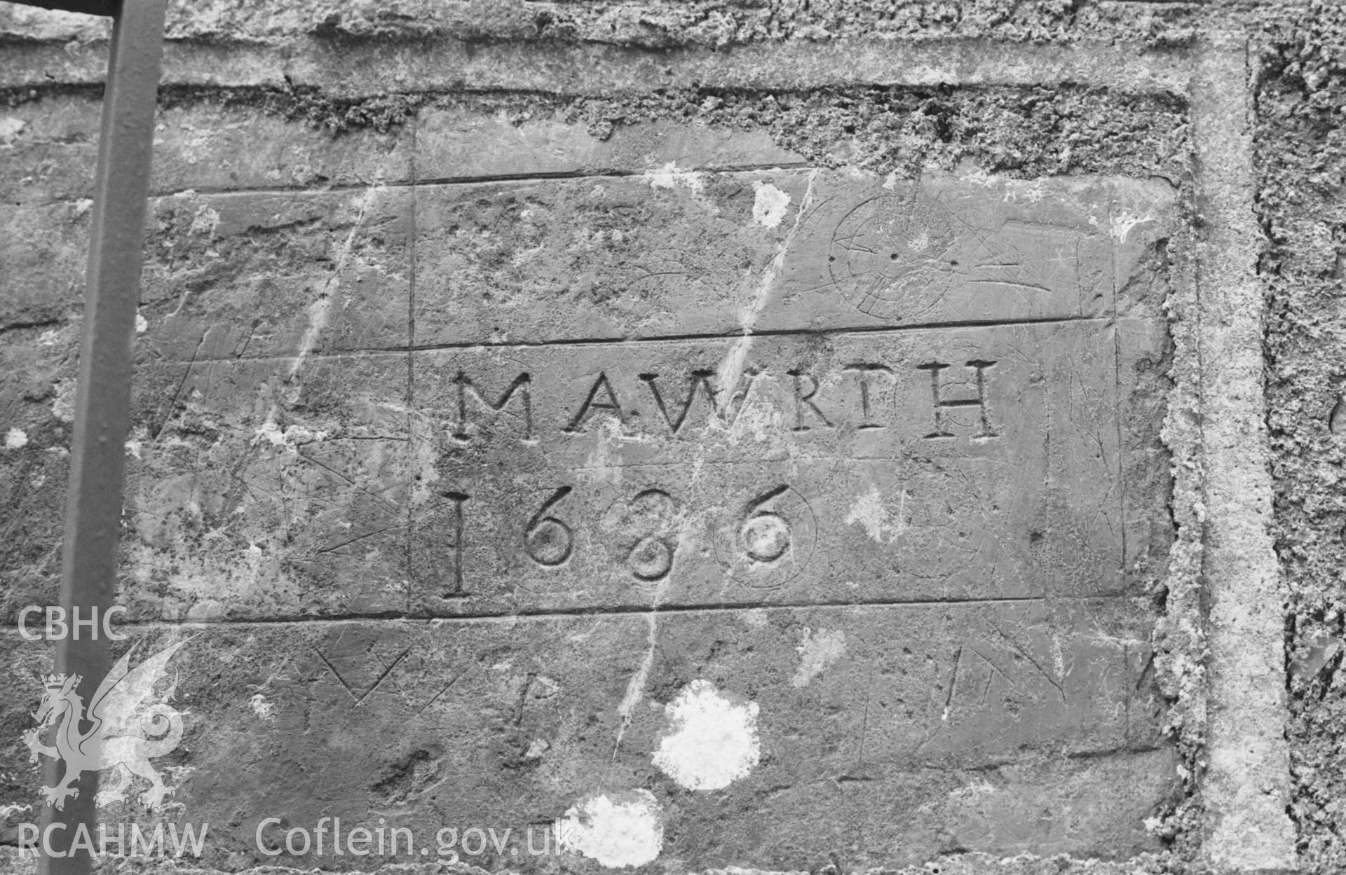 Digital copy of a black and white negative showing inscribed stone, said to have come from the old church at Llangwyrfon, built into the gatepost of the new church. Photographed by Arthur Chater on 27 August 1969, looking north east from Grid Reference SN 5965 7052.