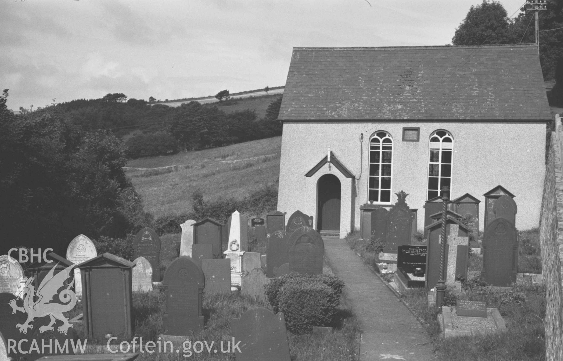 Digital copy of a black and white negative showing Capel Llwyndafydd (Baptist) from the graveyard. Photographed by Arthur Chater on 28 August 1969, looking north west from Grid Reference SN 3705 5558.