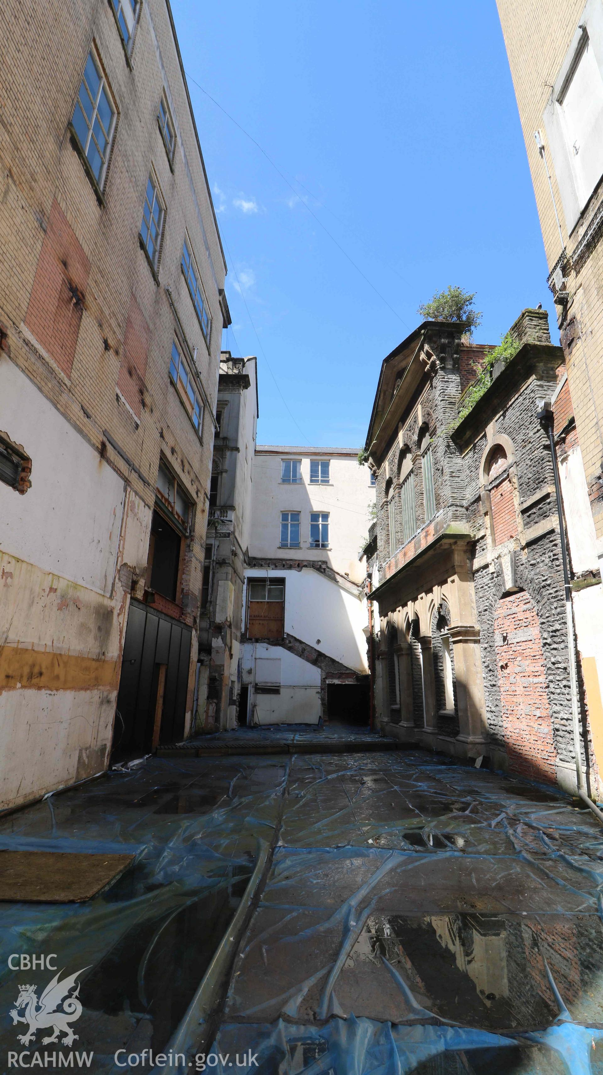 Photograph showing external space - previously demolished modern infill, from a Level 4 Historic Building Record of the former Howells Department Store, Cardiff. Conducted as a part of listed building consent by Purcell Architecture in 2024.