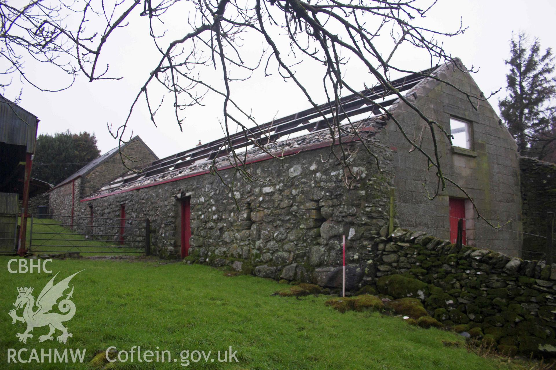 Photograph showing oblique view of elevation, from an Historic Building Record Level 1 for Outbuilding at Penrhyn, Rhydlydan, Pentrefoelas, carried out by Aeon Archaeology in 2022. Report no: 0327. Project code A0348.1.