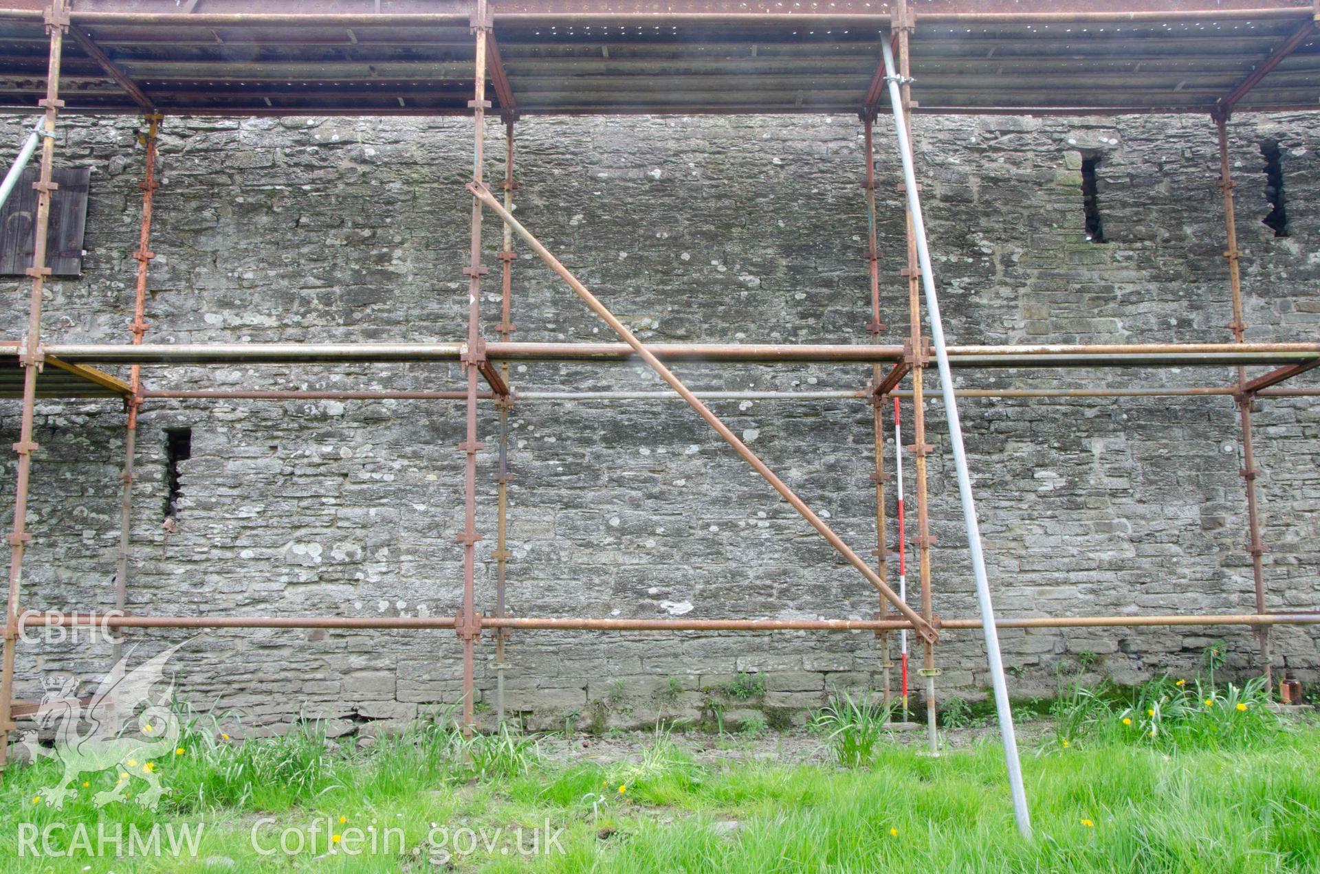 Photograph showing Cartshed external south elevation, showing location of blocked full-height door, from a Photographic Survey of outbuildings at Upper House Farm Evenjobb, submitted as part of Listed Building consent. Photograph taken by Christopher Welch in April/June 2024.