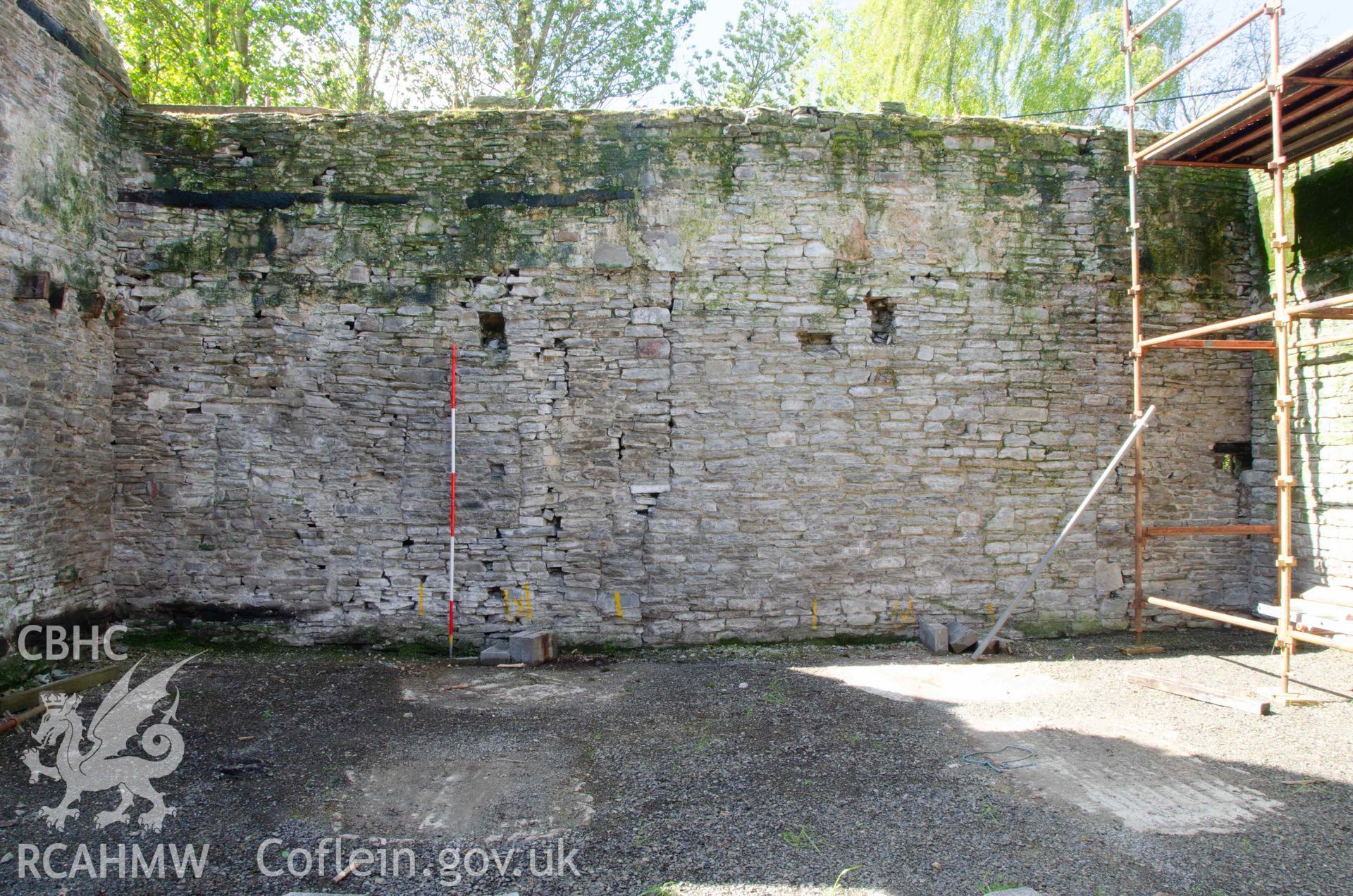 Photograph showing Cartshed internal elevation, showing location of blocked full-height door, from a Photographic Survey of outbuildings at Upper House Farm Evenjobb, submitted as part of Listed Building consent. Photograph taken by Christopher Welch in April/June 2024.