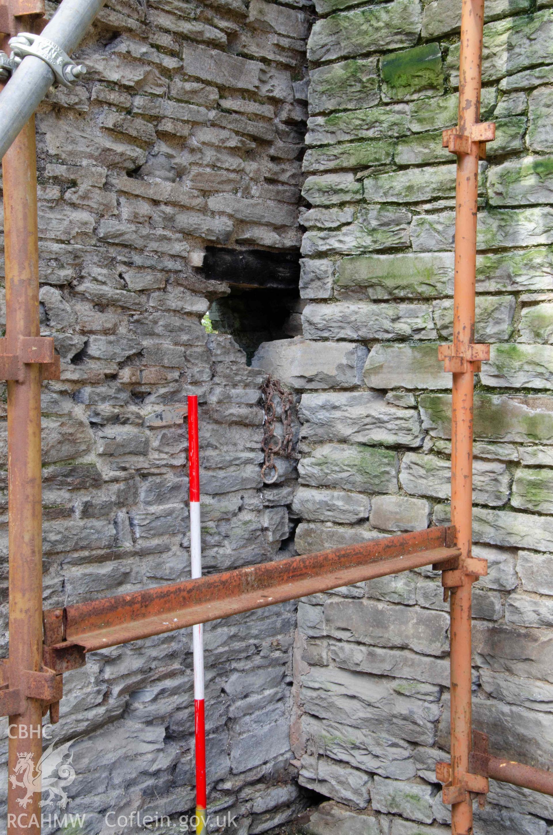Photograph showing Cartshed internal elevation, showing  Junction of east wall of barn and south wall of preceding barn, showing the partially blocked ‘arrowslit’, from a Photographic Survey of outbuildings at Upper House Farm Evenjobb, submitted as part of Listed Building consent. Photograph taken by Christopher Welch in April/June 2024.