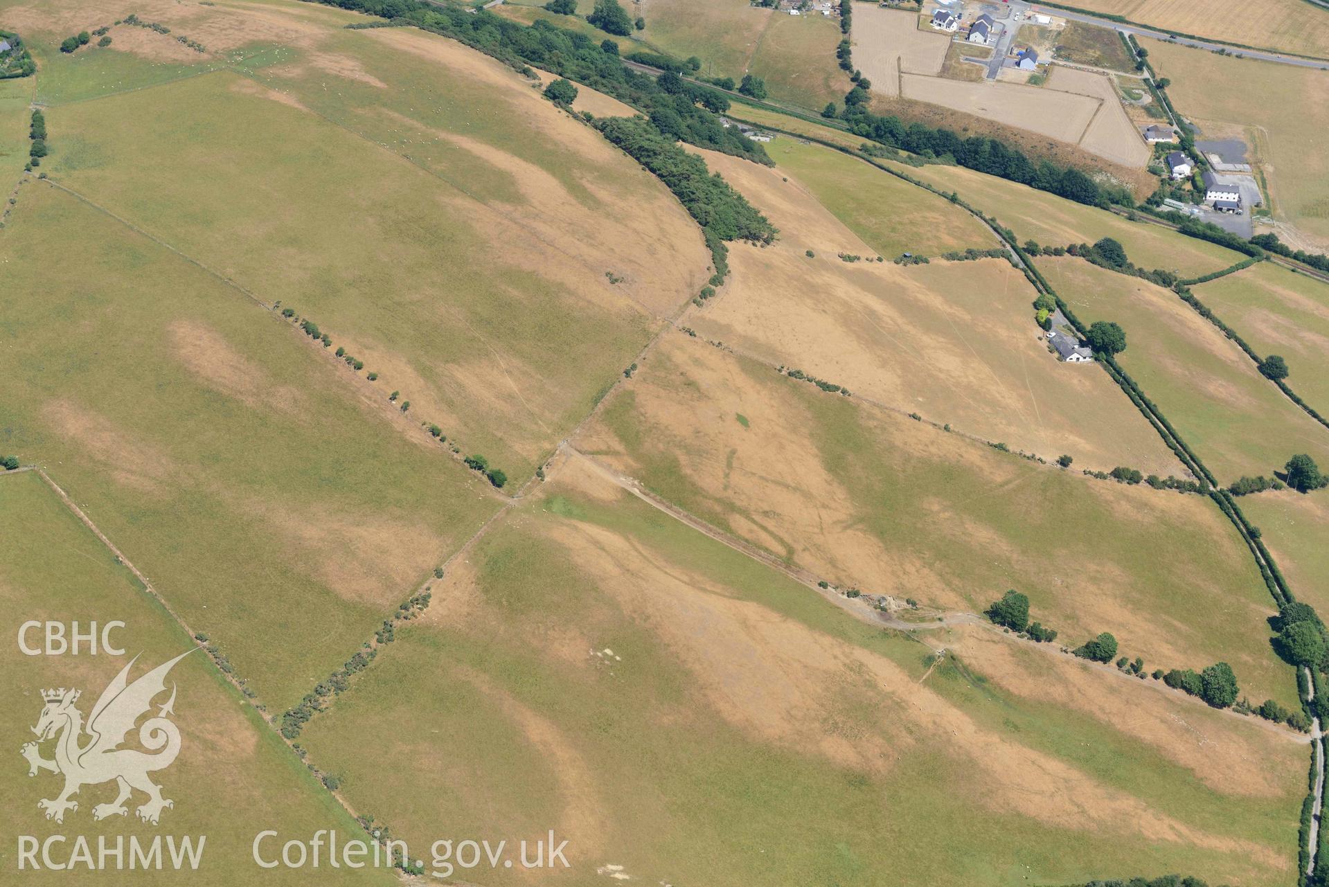 Ruel Uchaf enclosure. Oblique aerial photograph taken during the Royal Commission’s programme of archaeological aerial reconnaissance by Toby Driver on 10 July 2018.