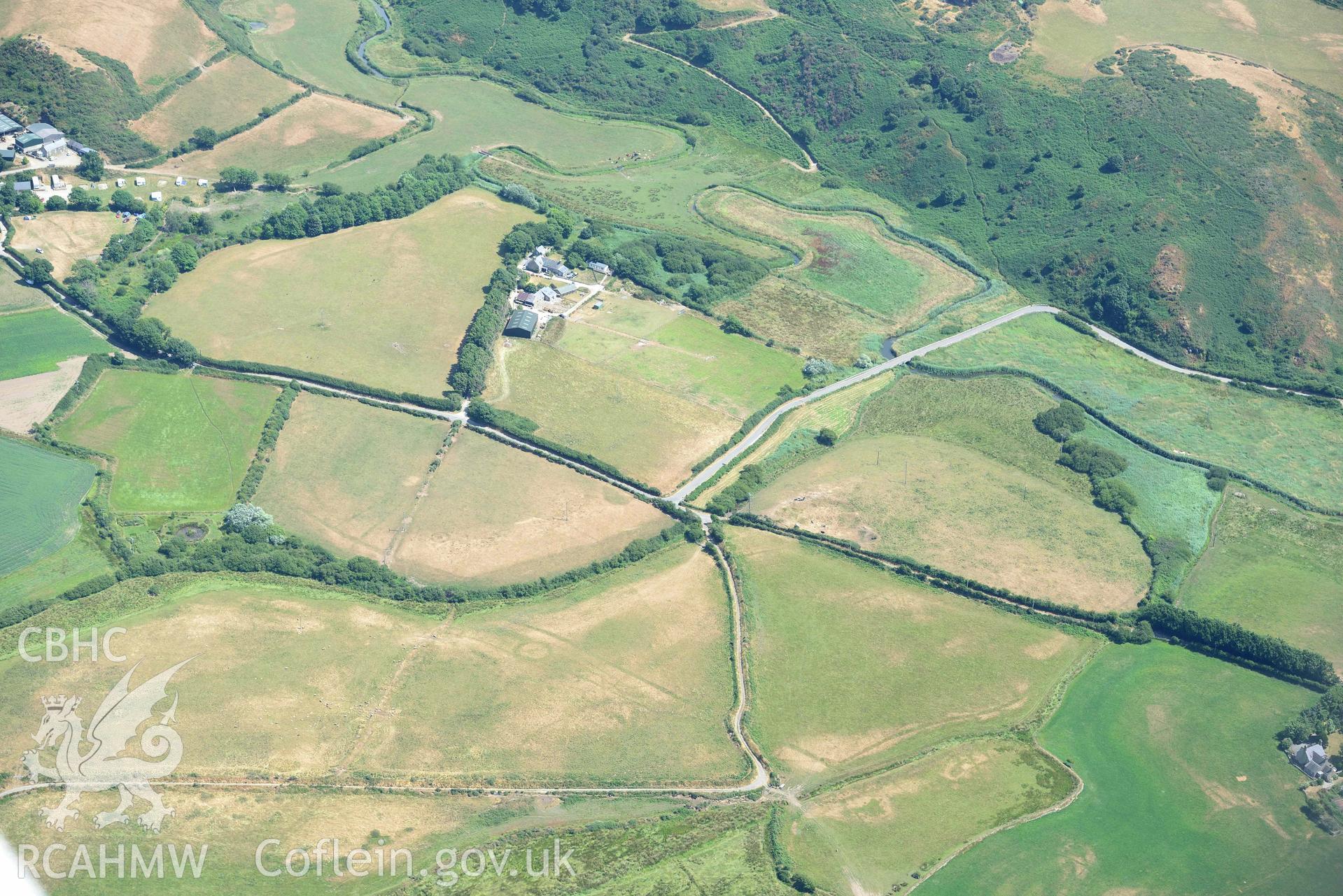 Cropmark complex at Llawr-Dref, Llangian. Oblique aerial photograph taken during the Royal Commission’s programme of archaeological aerial reconnaissance by Toby Driver on 10 July 2018.